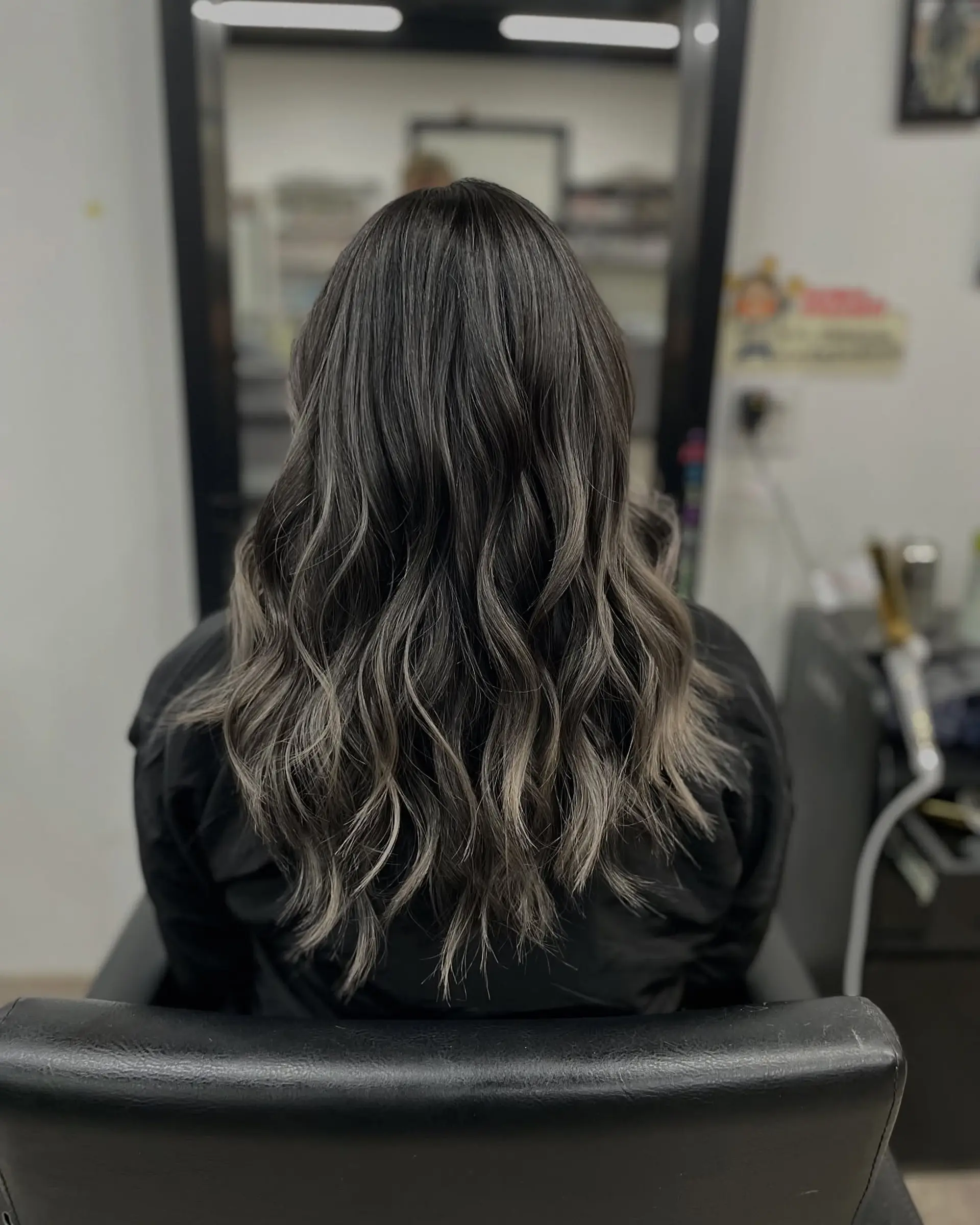 Long, wavy hairstyle with layered ends and an ash blonde balayage. 1