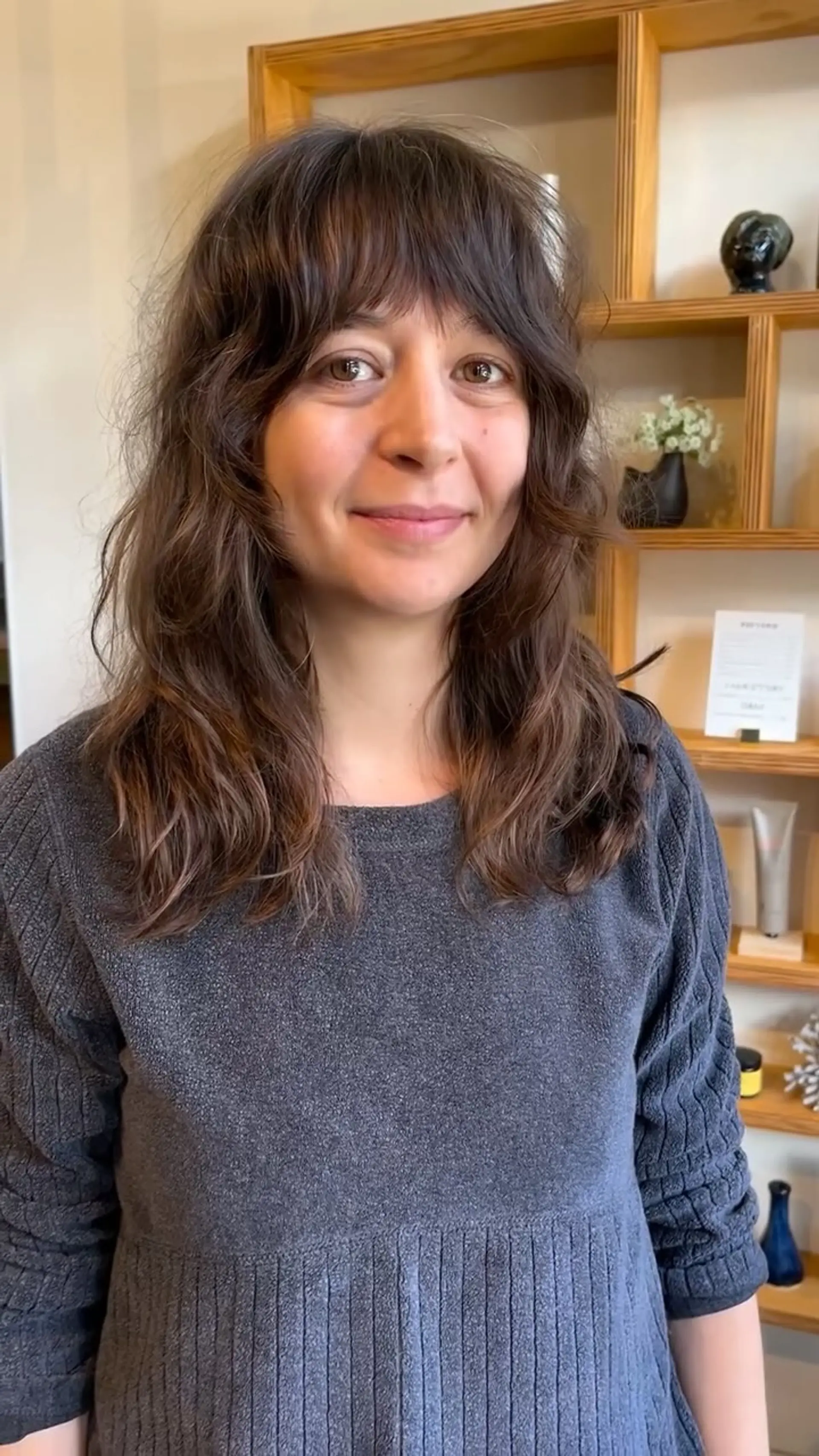 A medium-length shag cut featuring soft wavy texture, face-framing layers, and curtain bangs. 1