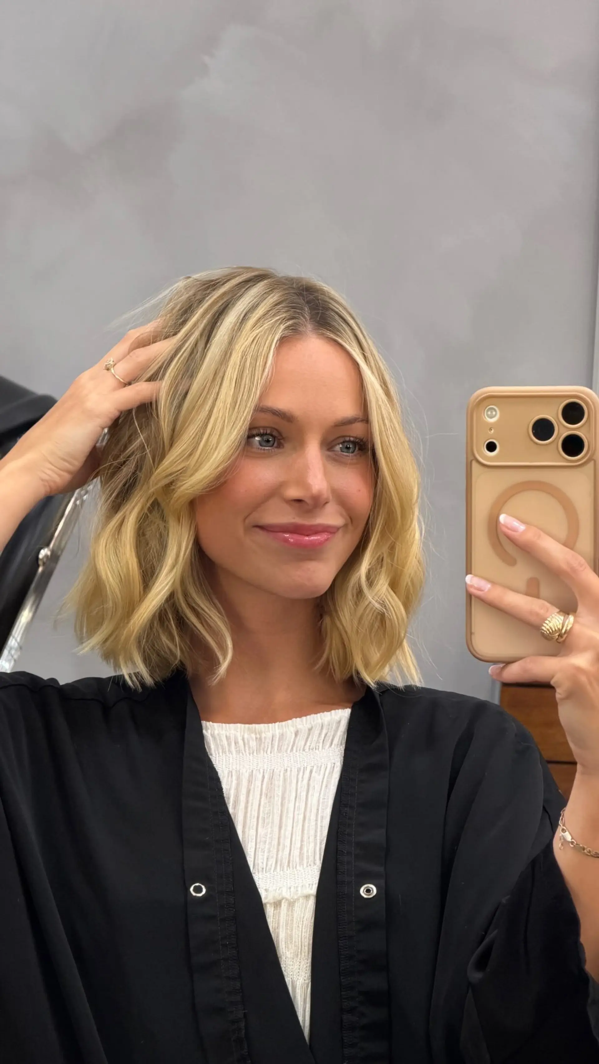 A textured shoulder-length blonde bob styled in relaxed, beachy waves with soft face-framing pieces. 1