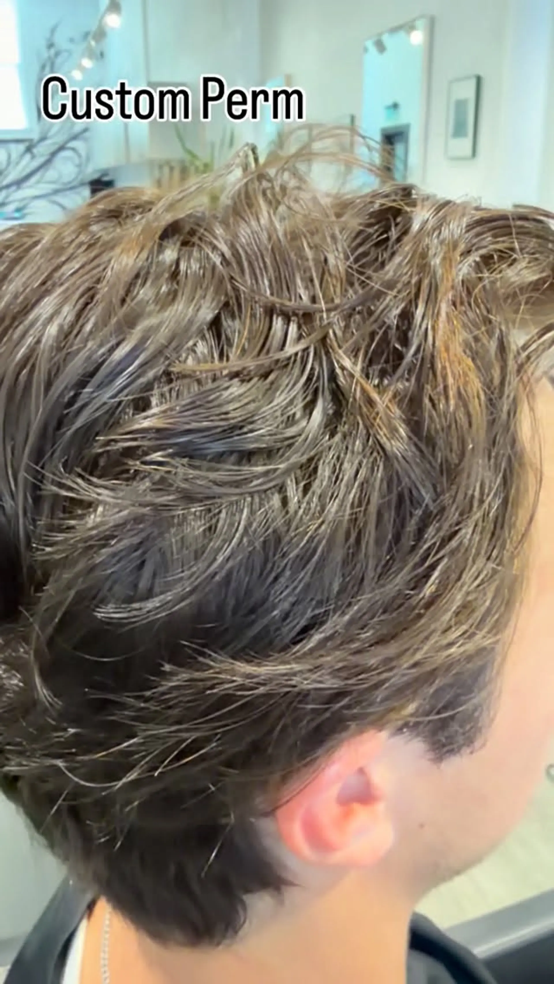 A textured two-block cut enhanced with custom soft perm waves and defined, piecey styling. 1