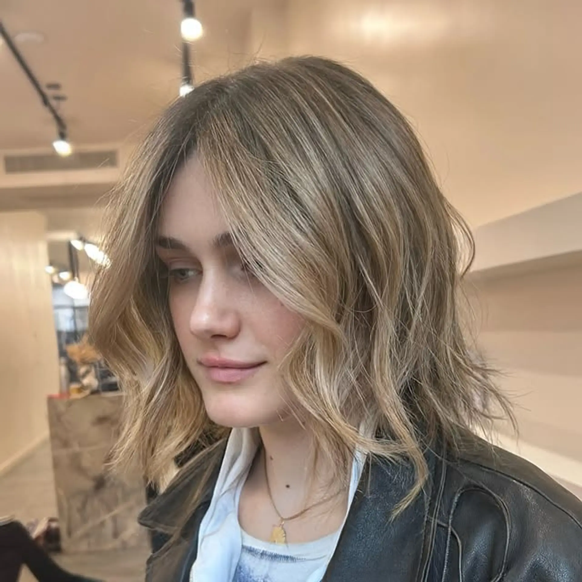 A wavy, medium-length lob with beachy waves and subtle layering. 1