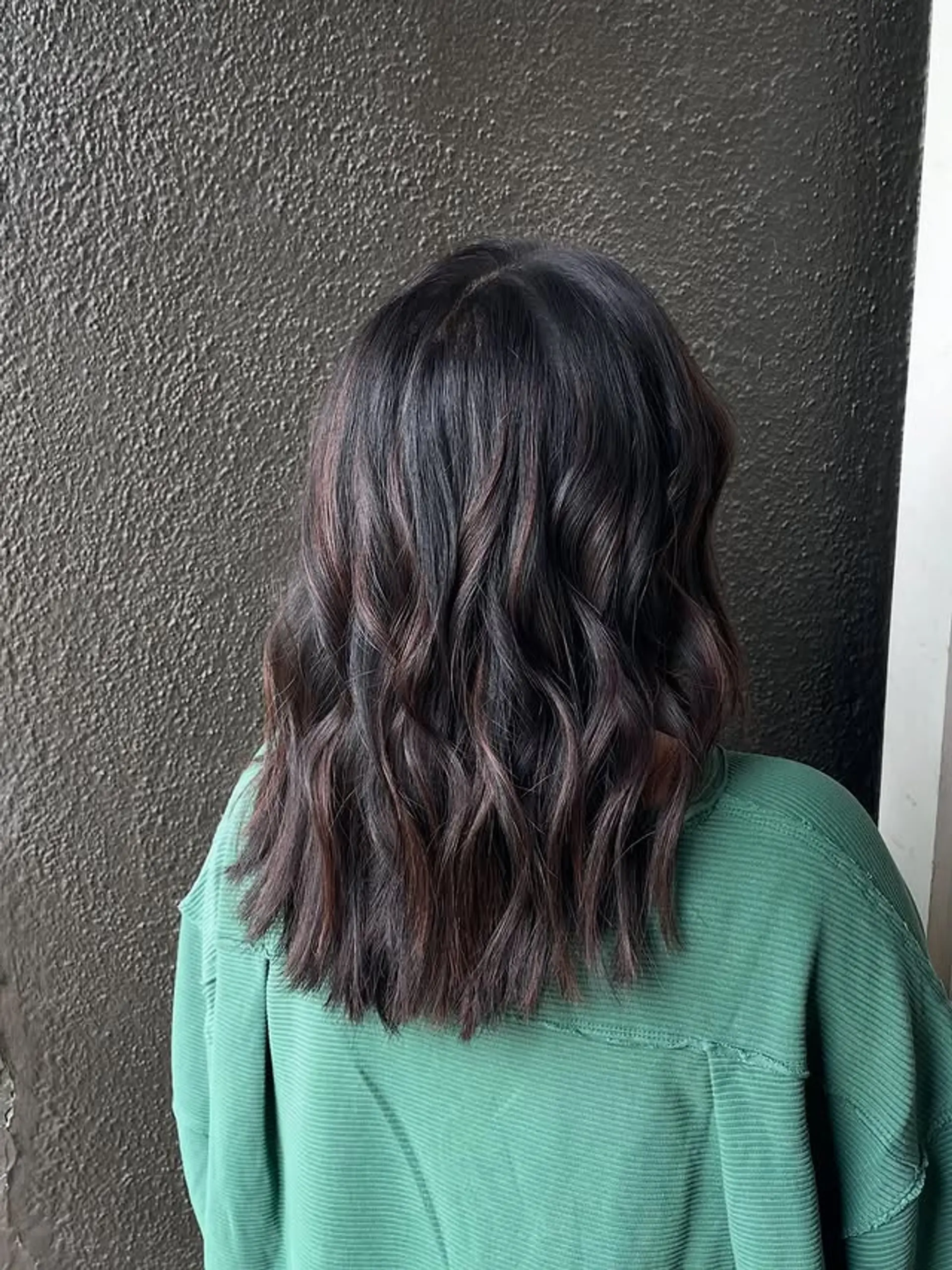 A wavy lob with a chocolate swirl balayage and root melt. 1