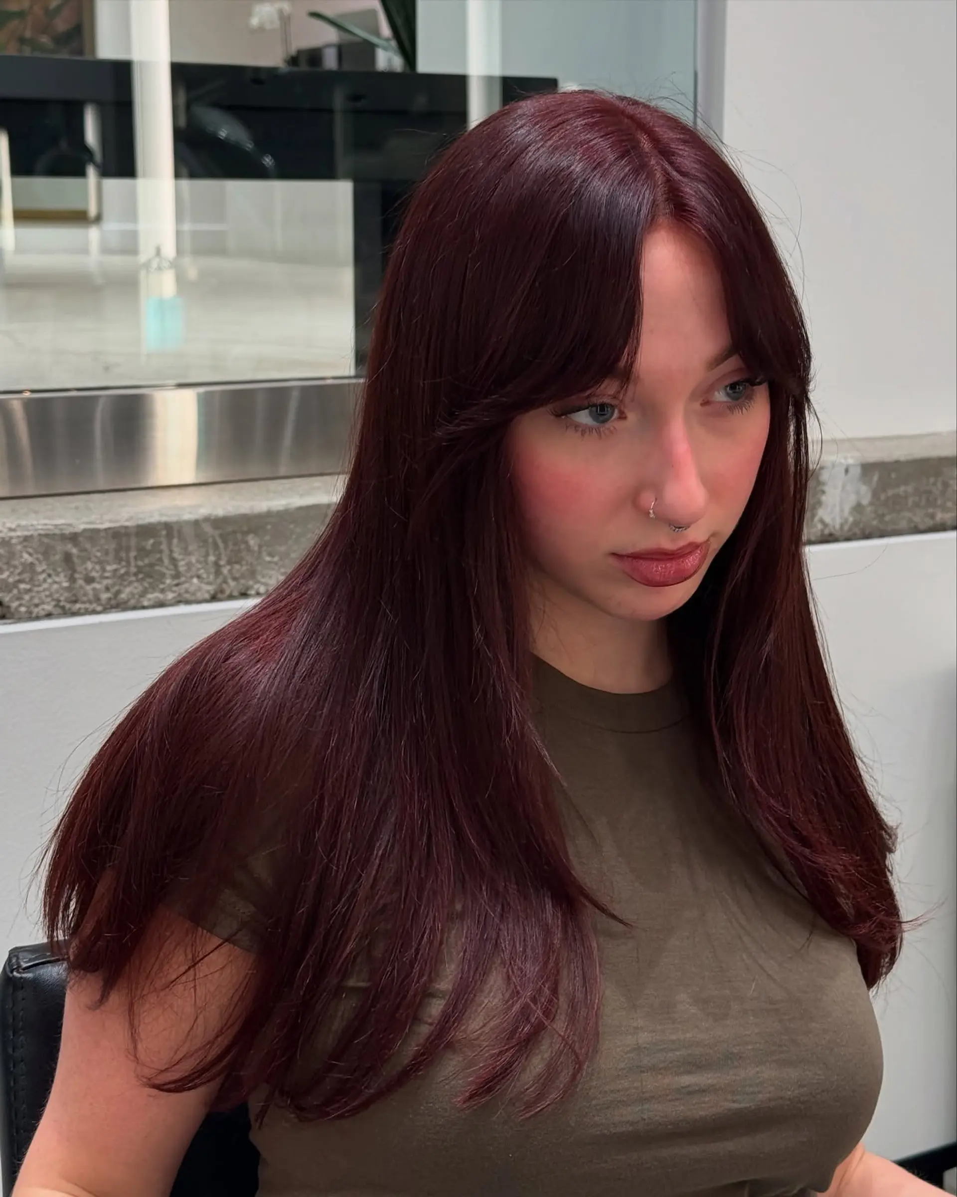 Long, straight hair with face-framing layers and trendy curtain bangs. 1