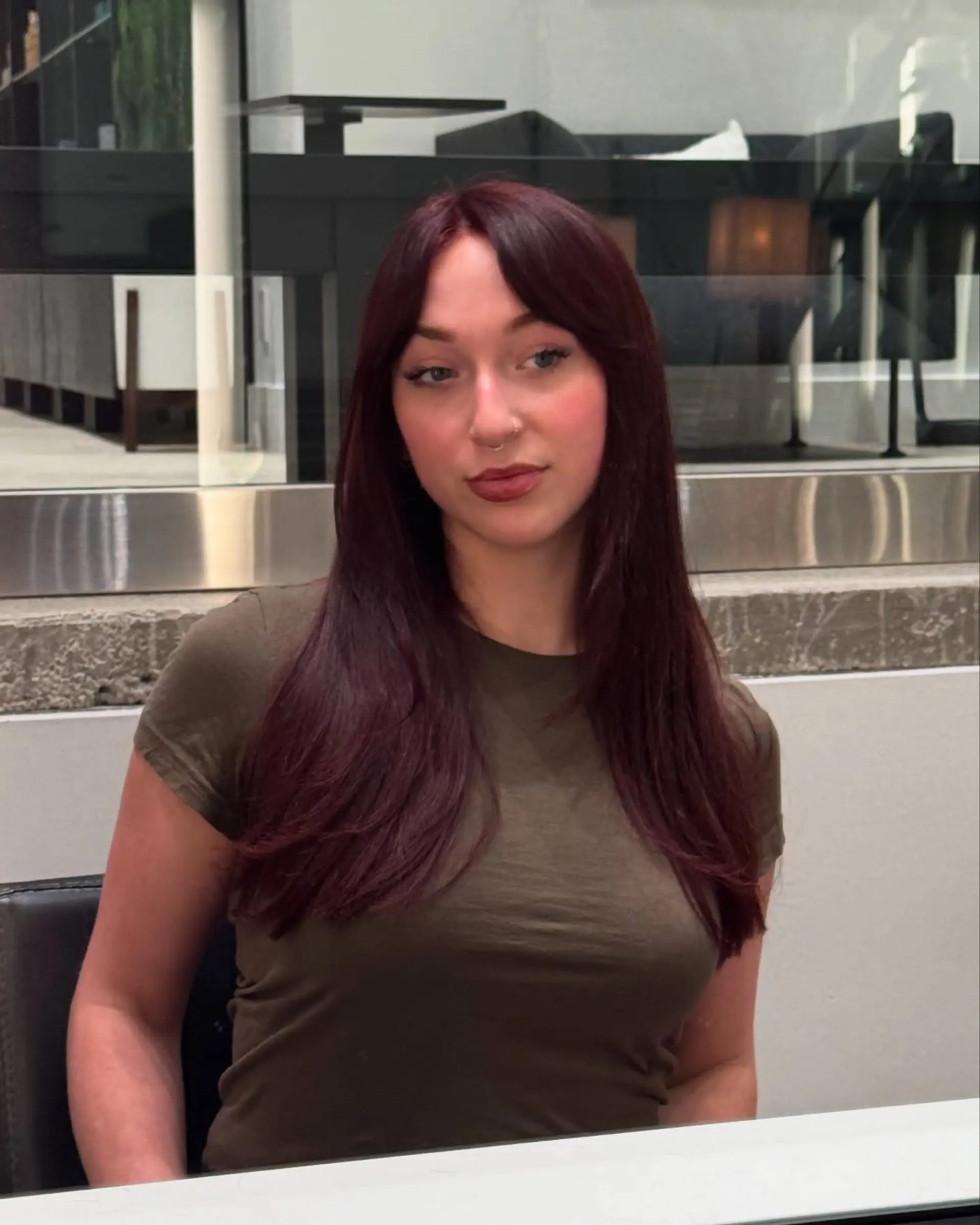 Long, straight hair with face-framing layers and trendy curtain bangs. 3