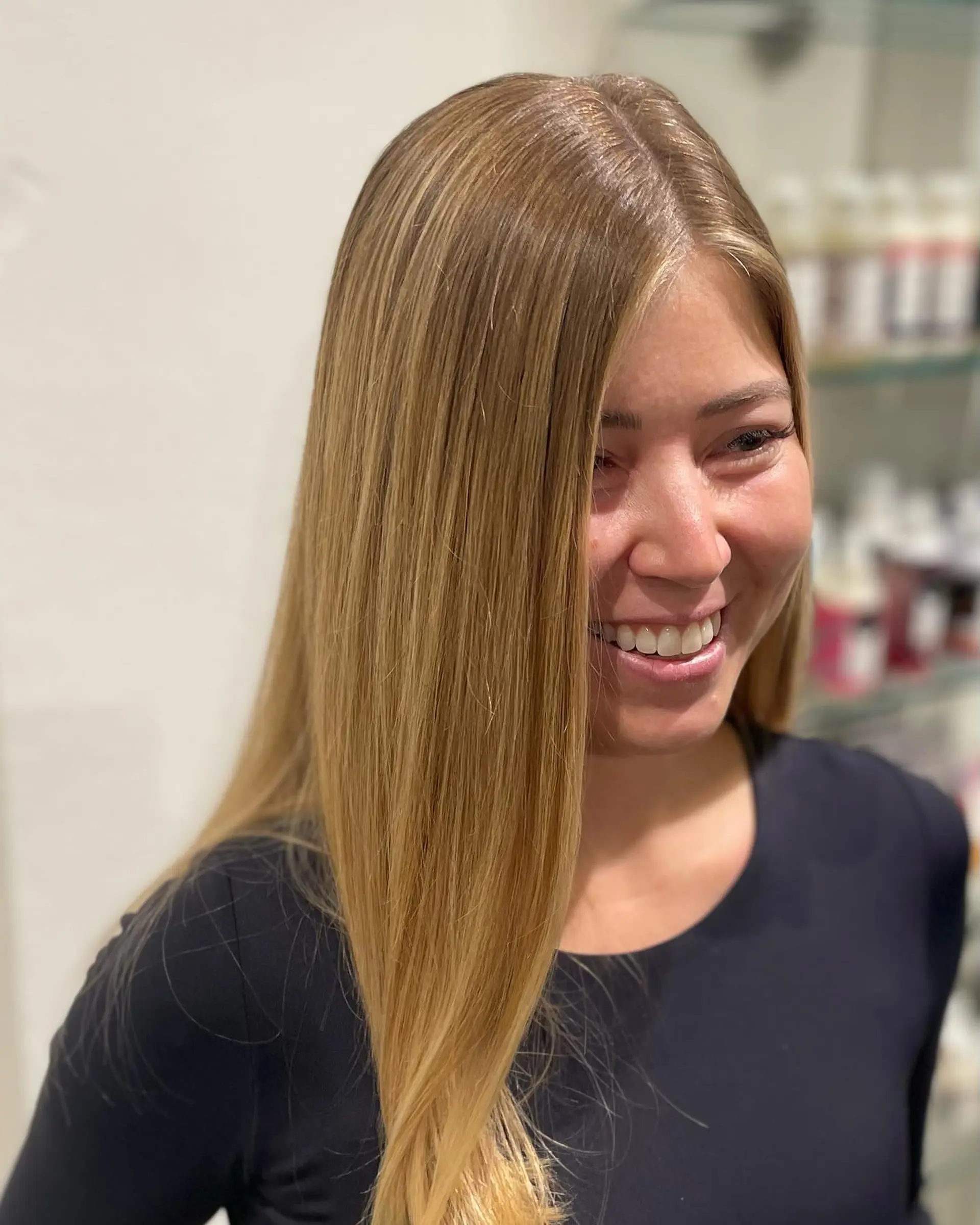 Sleek and straight long hair featuring a multi-dimensional warm golden blonde balayage. 1