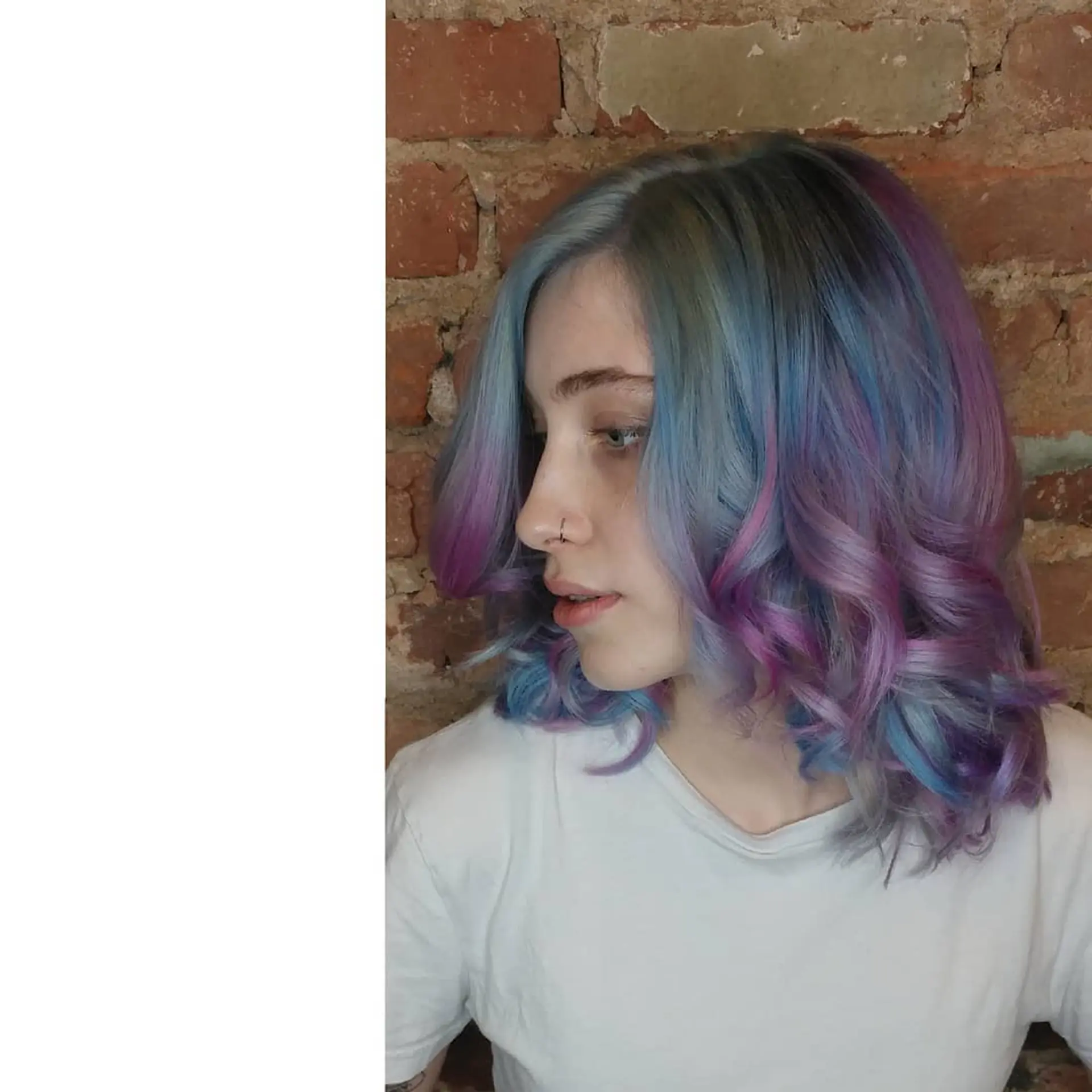 Medium-length layered hair featuring a pastel blend of soft blue, lavender, and pink tones styled in voluminous curls. 1