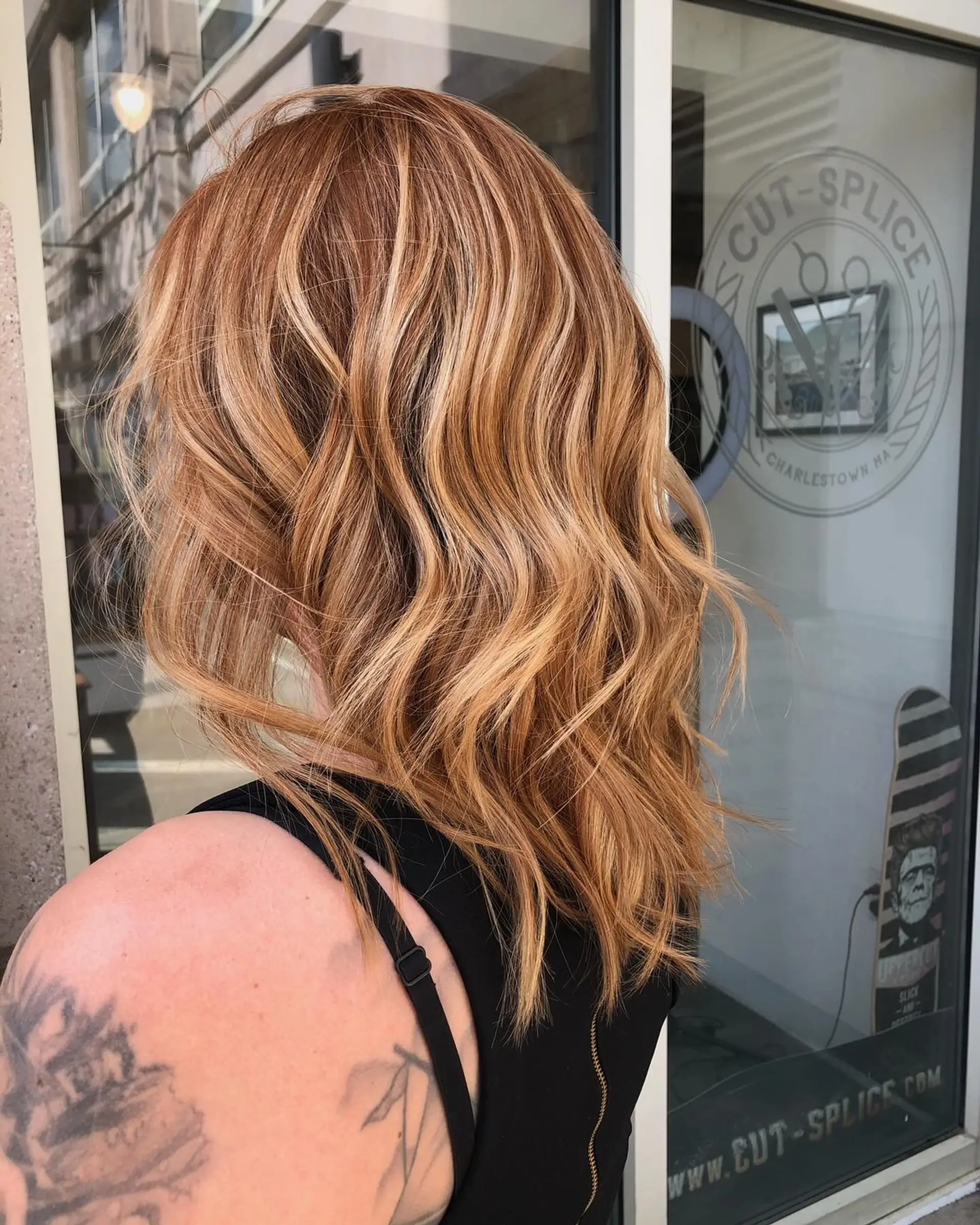 Medium-length textured hair styled in relaxed, loose waves with rich honey and golden blonde highlights. 1