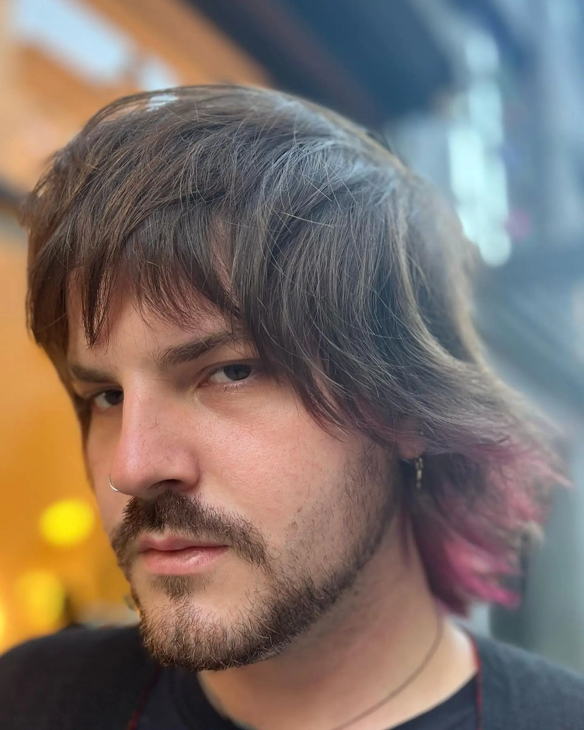 The hairstyle features medium-length straight hair with a natural brown base, accented by undercut pink highlights. Shaggy layers and feathered ends create an edgy look, complemented by a side-swept fringe. 2