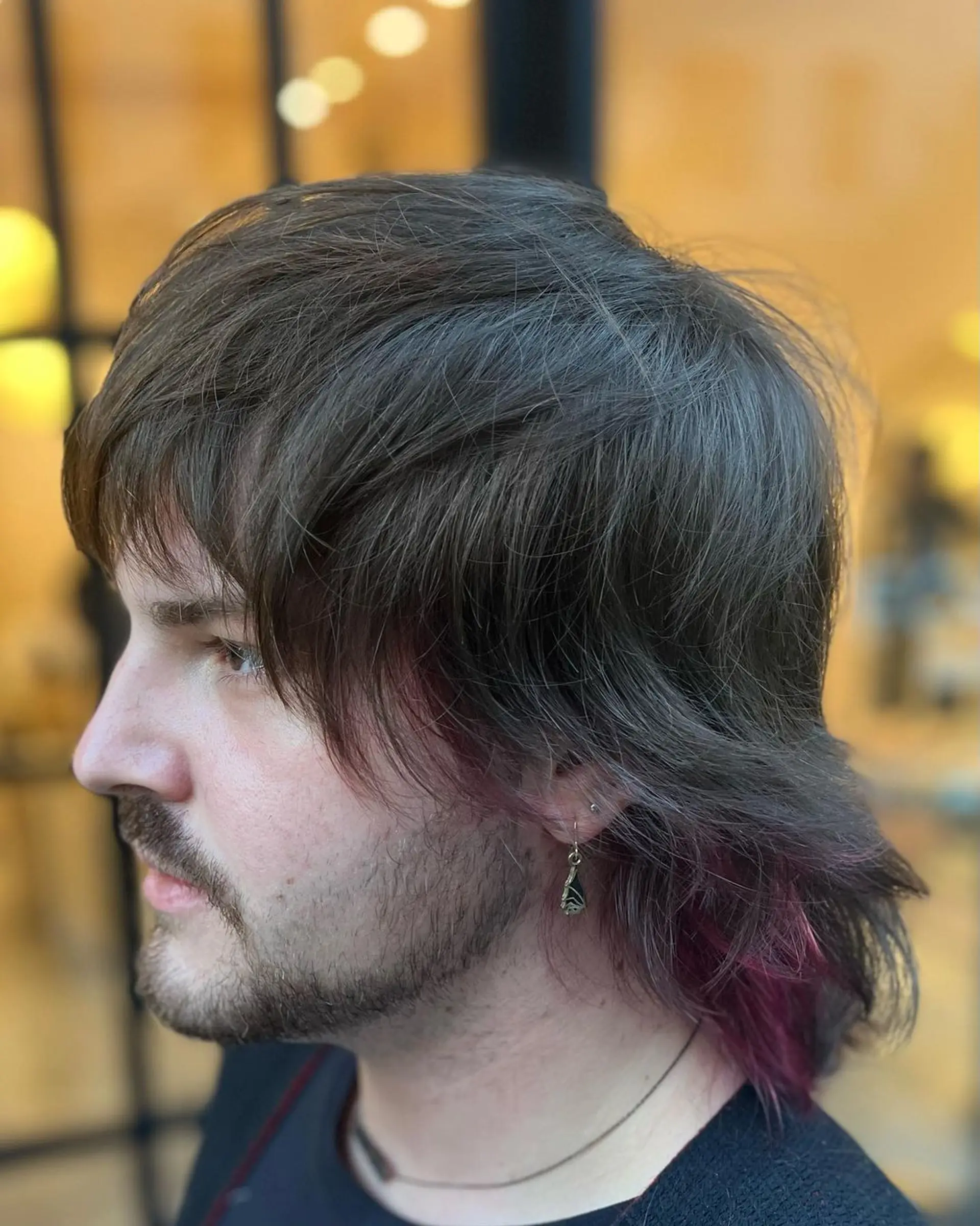 The hairstyle features medium-length straight hair with a natural brown base, accented by undercut pink highlights. Shaggy layers and feathered ends create an edgy look, complemented by a side-swept fringe. 1