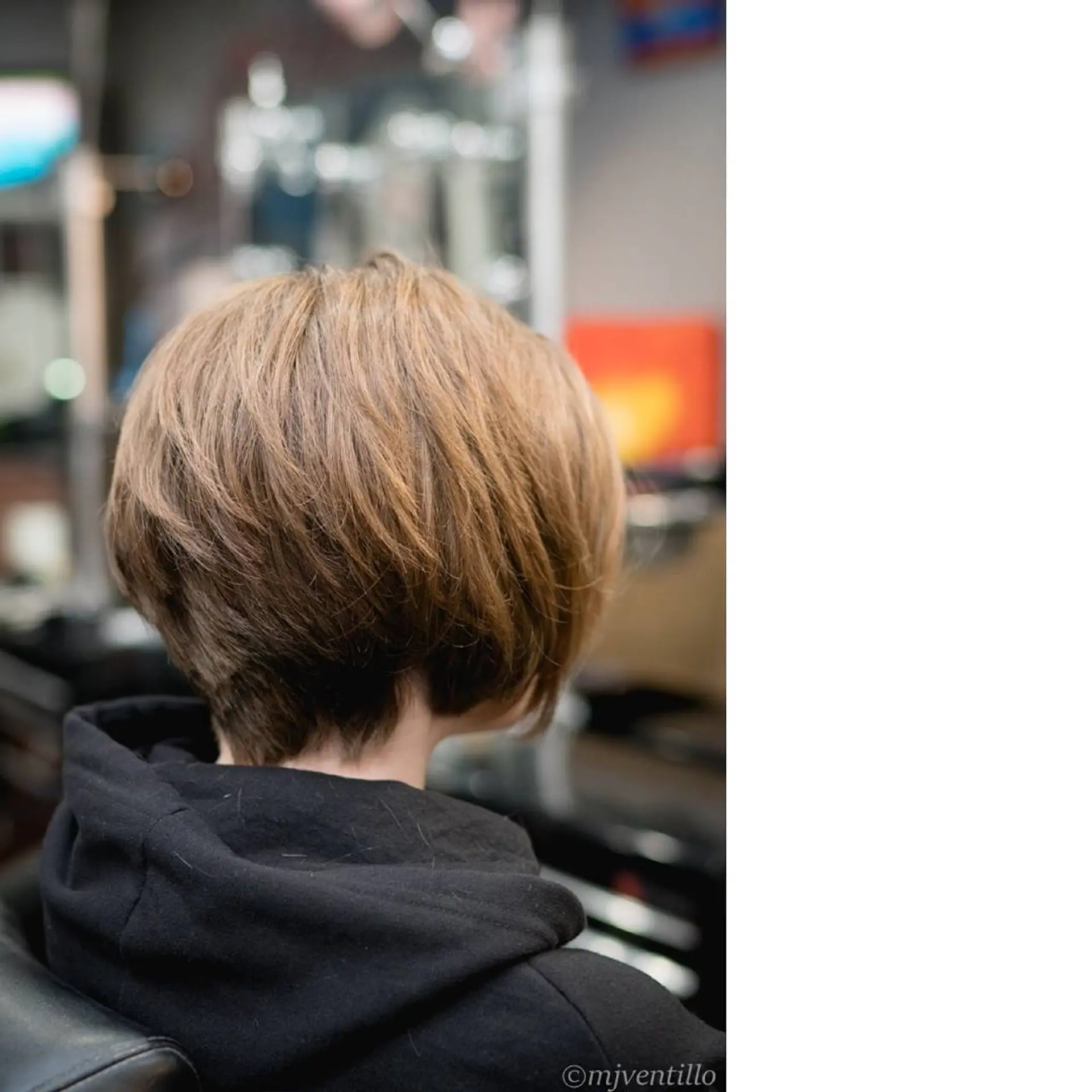 A textured short pixie bob haircut with soft crown volume and a softly tapered neckline. 1
