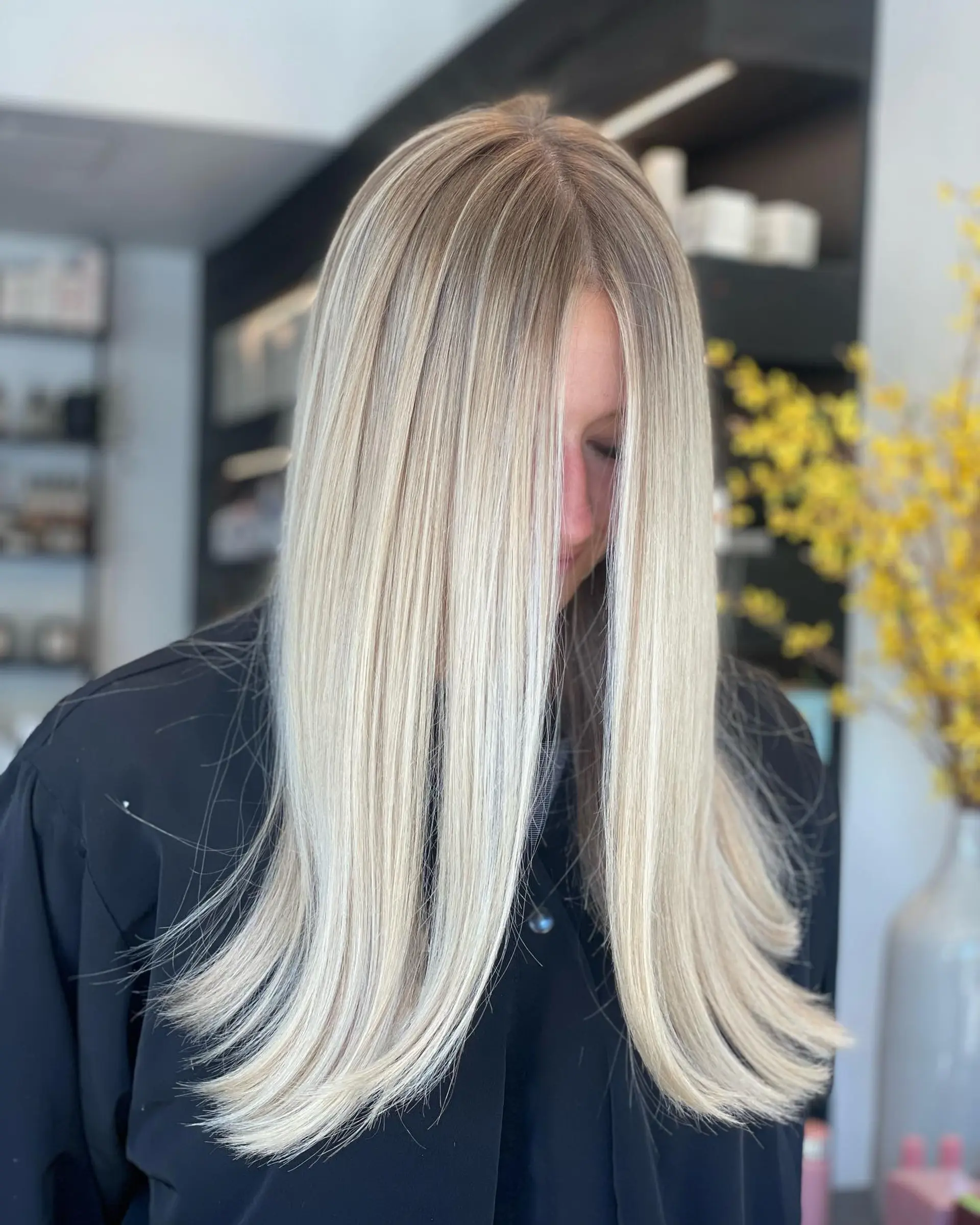 Long, ultra-smooth straight hair featuring an all-over bright platinum blonde with soft natural root shading. 1