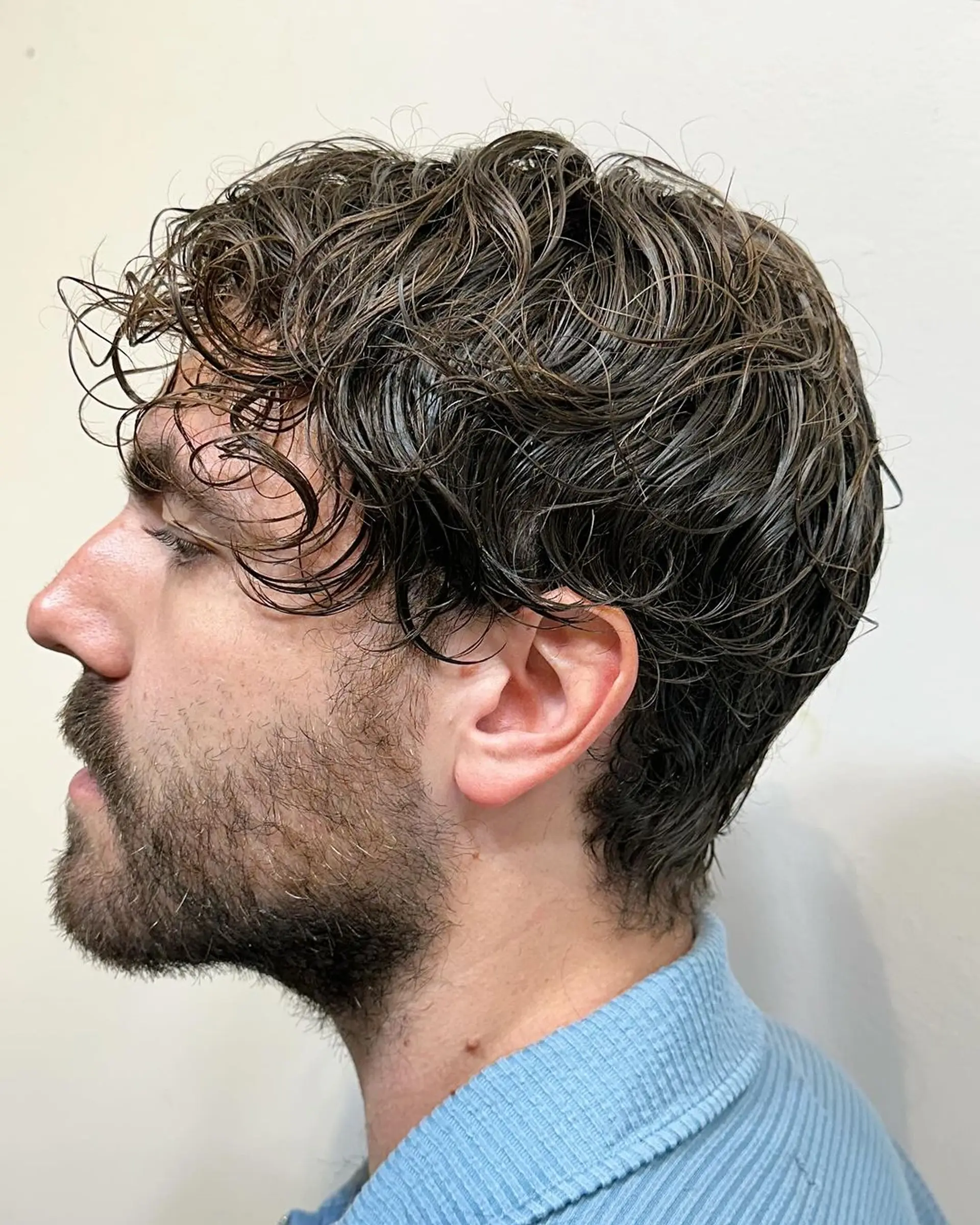 Medium-length, wavy brown hair with natural texture, lightly layered for a casual and tousled look. 1