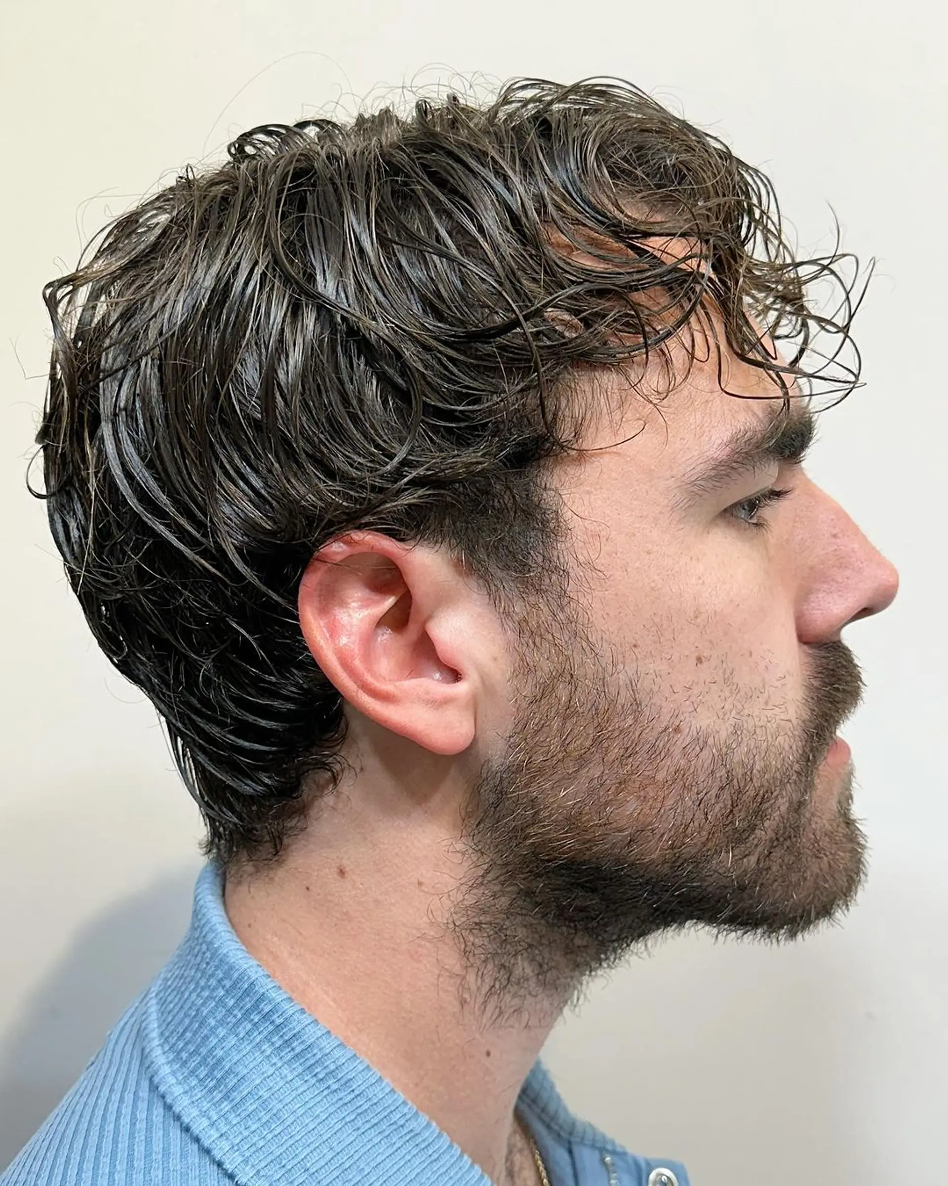 Medium-length, wavy brown hair with natural texture, lightly layered for a casual and tousled look. 2