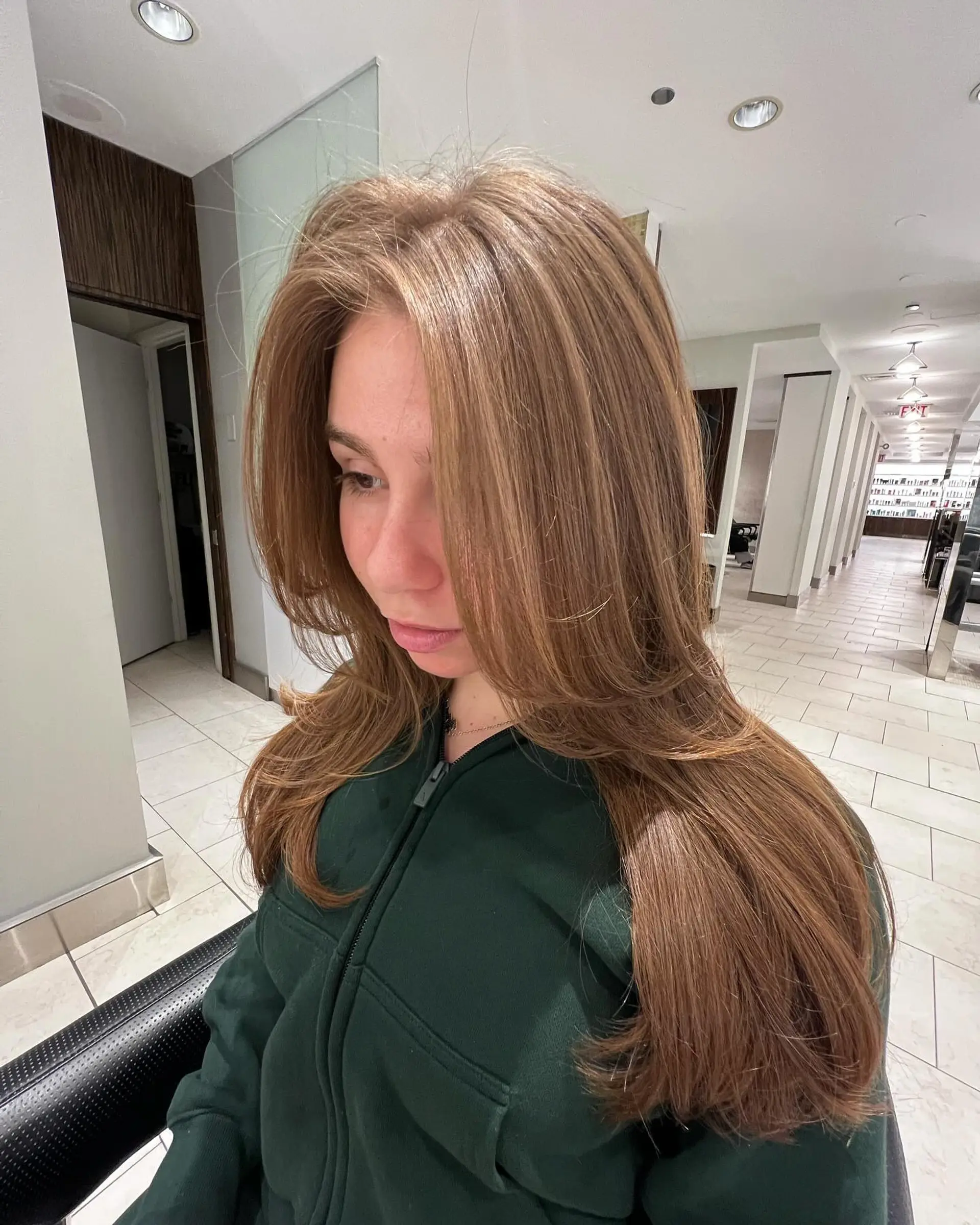 Long light brown hair styled with voluminous face-framing layers and a smooth blowout finish. 1