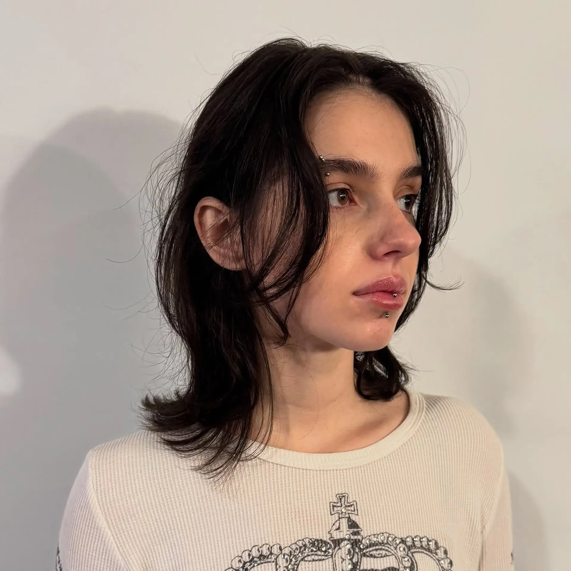 A textured medium-length shag with choppy face-framing layers and a soft, wavy finish. 1