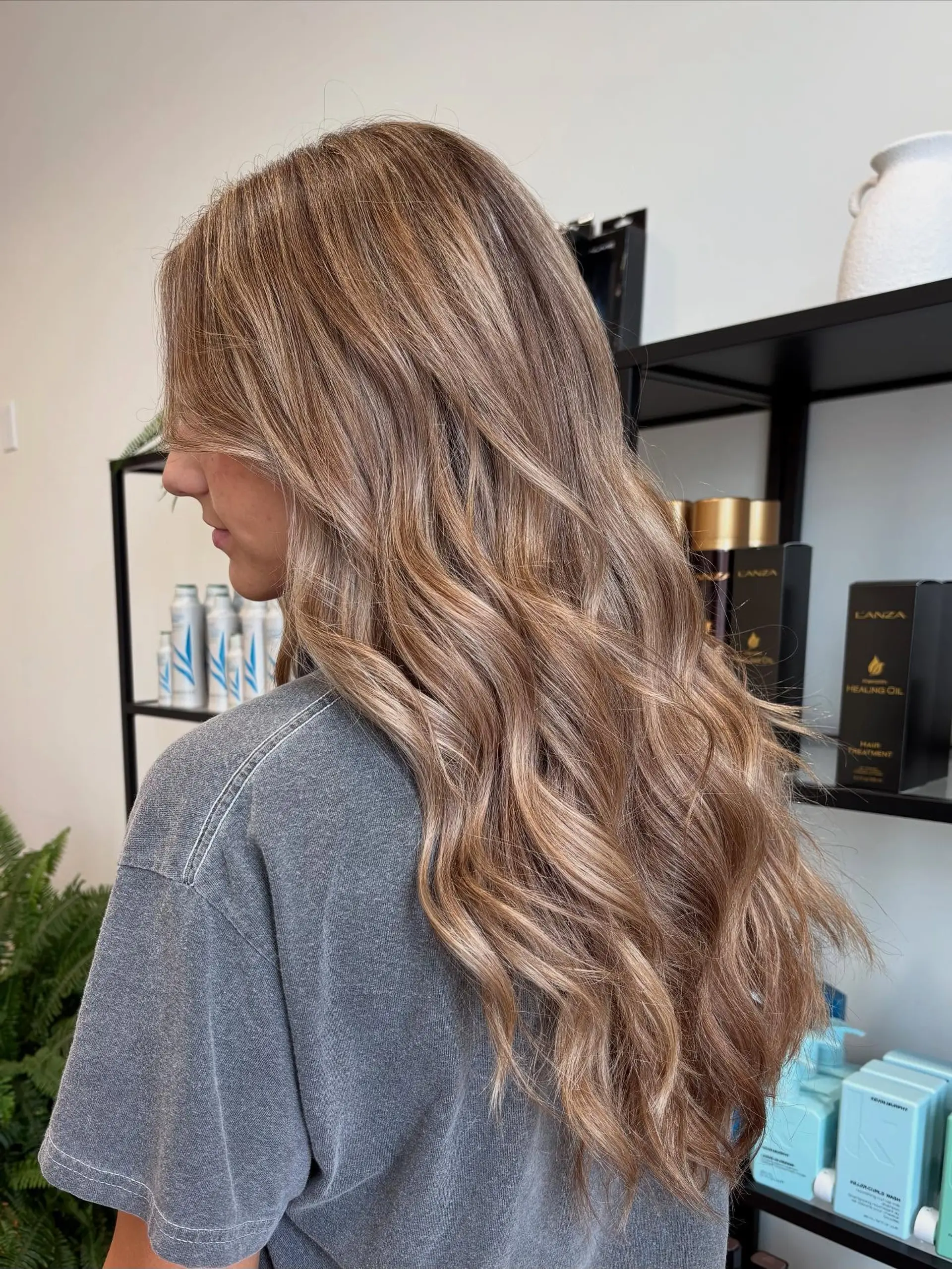 Long, dimensional bronde hair styled into soft, tousled waves. 1