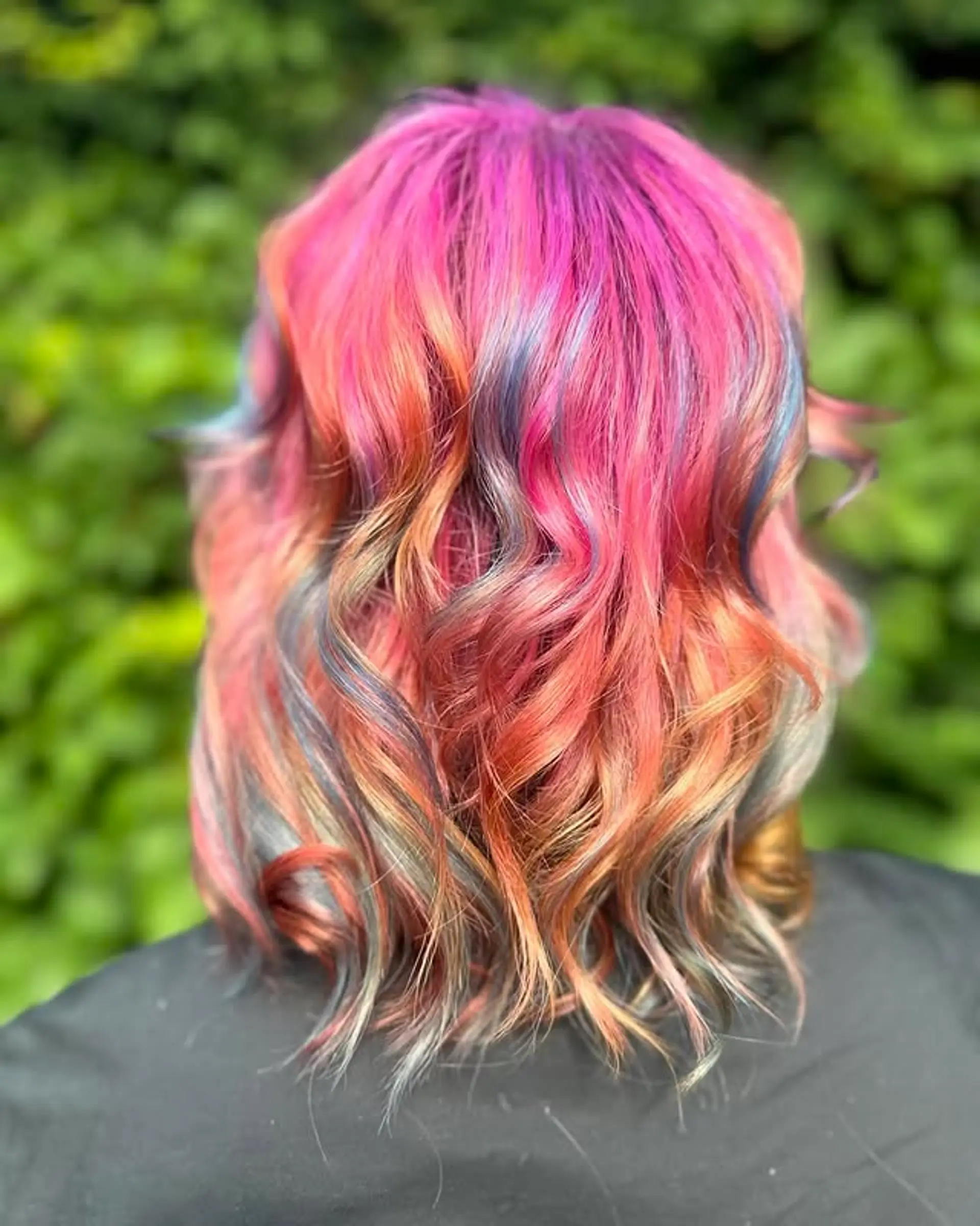 A wavy, medium-length hairstyle with a mix of vibrant fantasy colors. 1