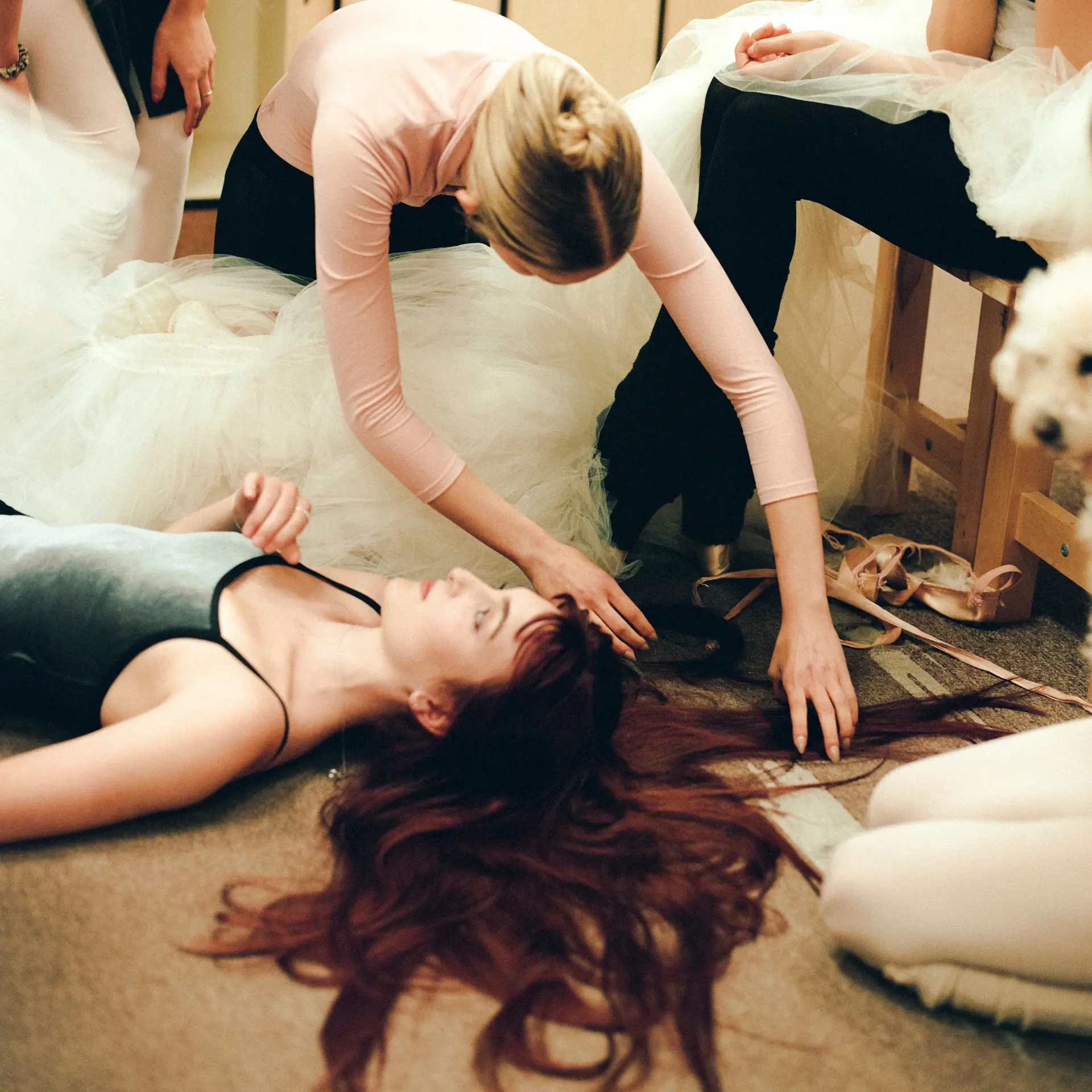 Rich auburn red hair styled in soft, natural waves spread across the floor in an editorial portrait. 1