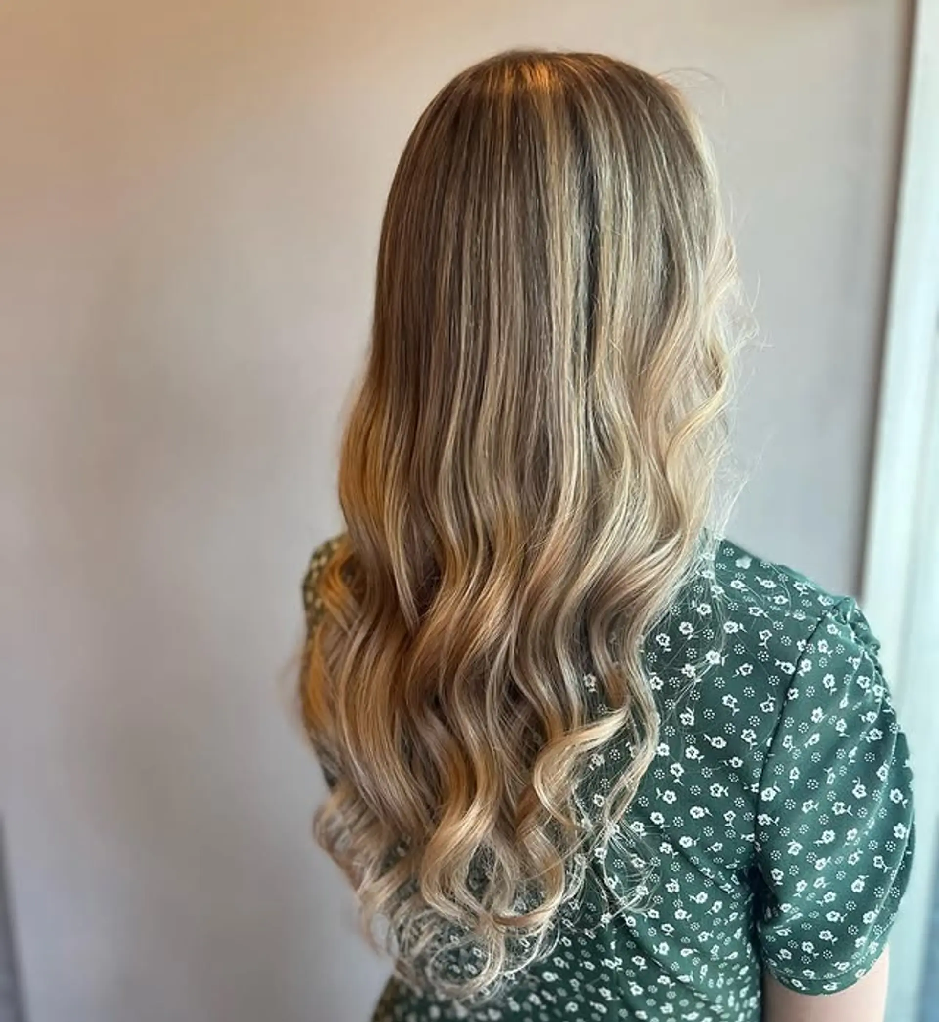 Long, wavy hairstyle with a golden blonde balayage. 1
