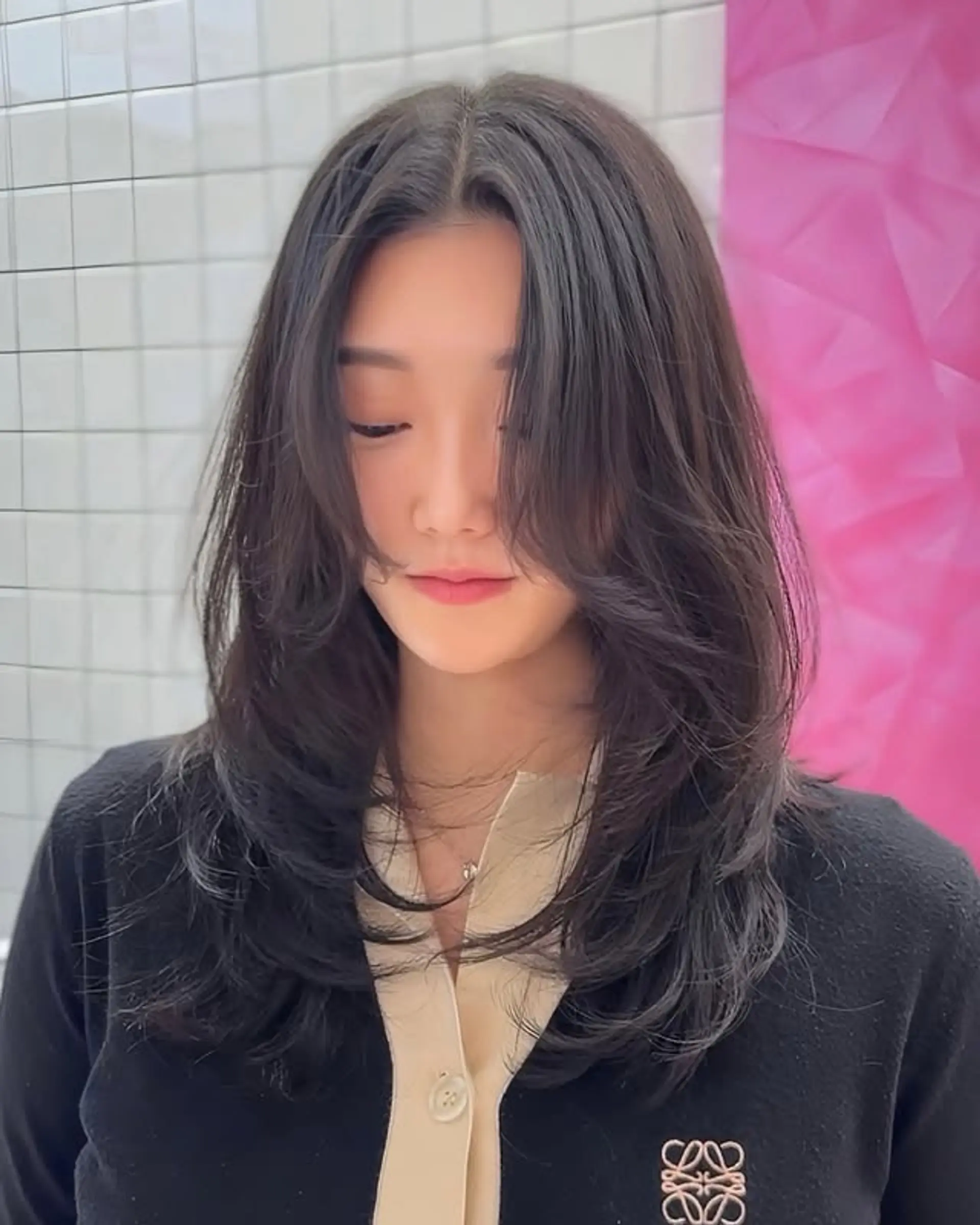 A medium-length haircut featuring soft, face-framing layers. 1