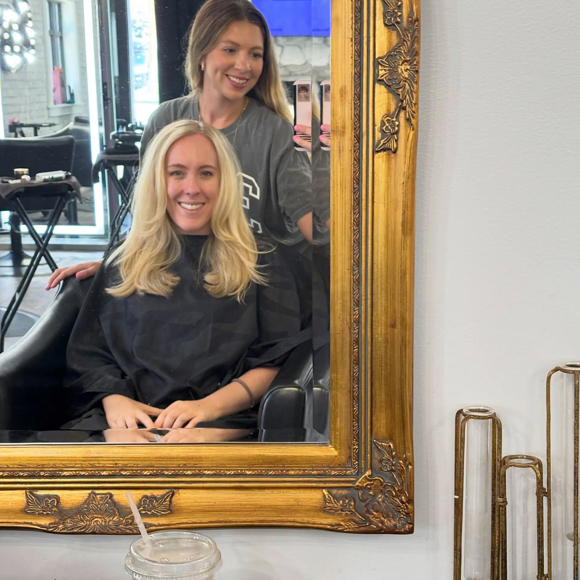 Medium-length bright blonde hair styled into a bouncy blowout with face-framing layers and soft curved ends. 1