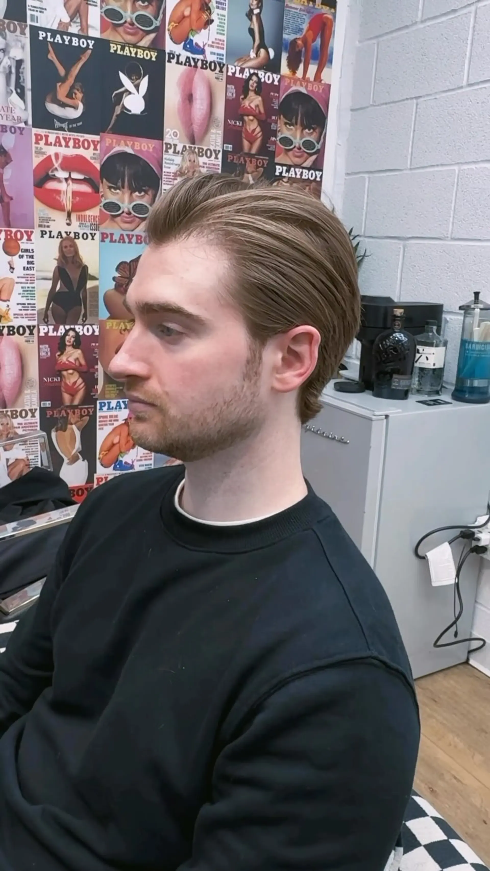 A classic men's scissor-cut style with hair swept neatly back from the forehead and sides tapered cleanly around the ears and neck. 1