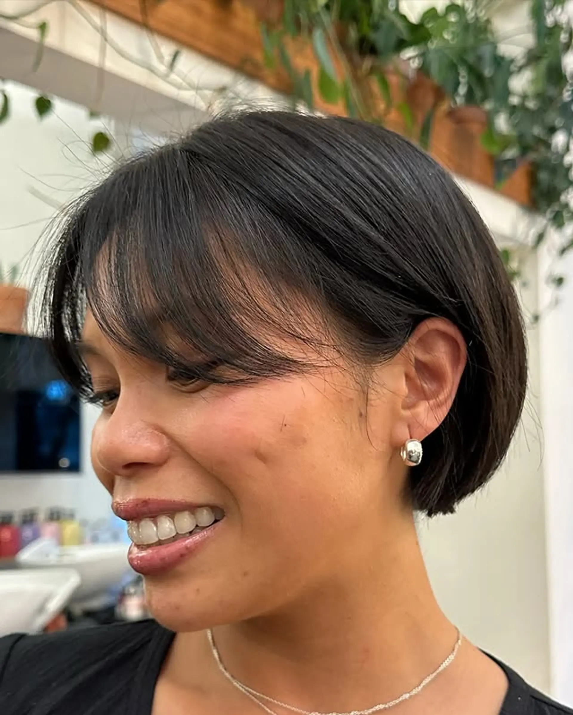 A classic French bob, cut to chin-length with straight, blunt bangs. 1