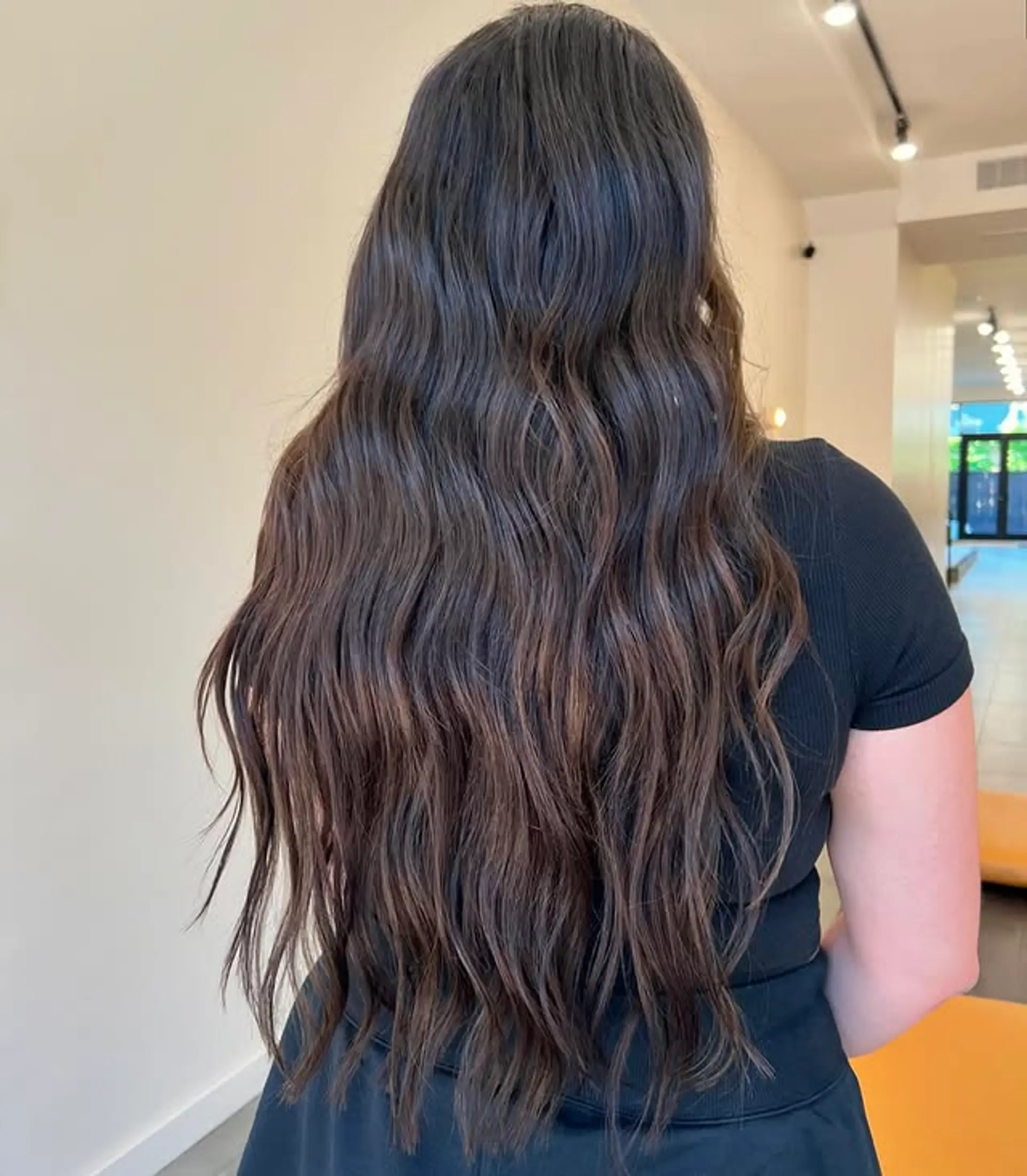 Long, layered wavy hair with a bronde color melt. 1