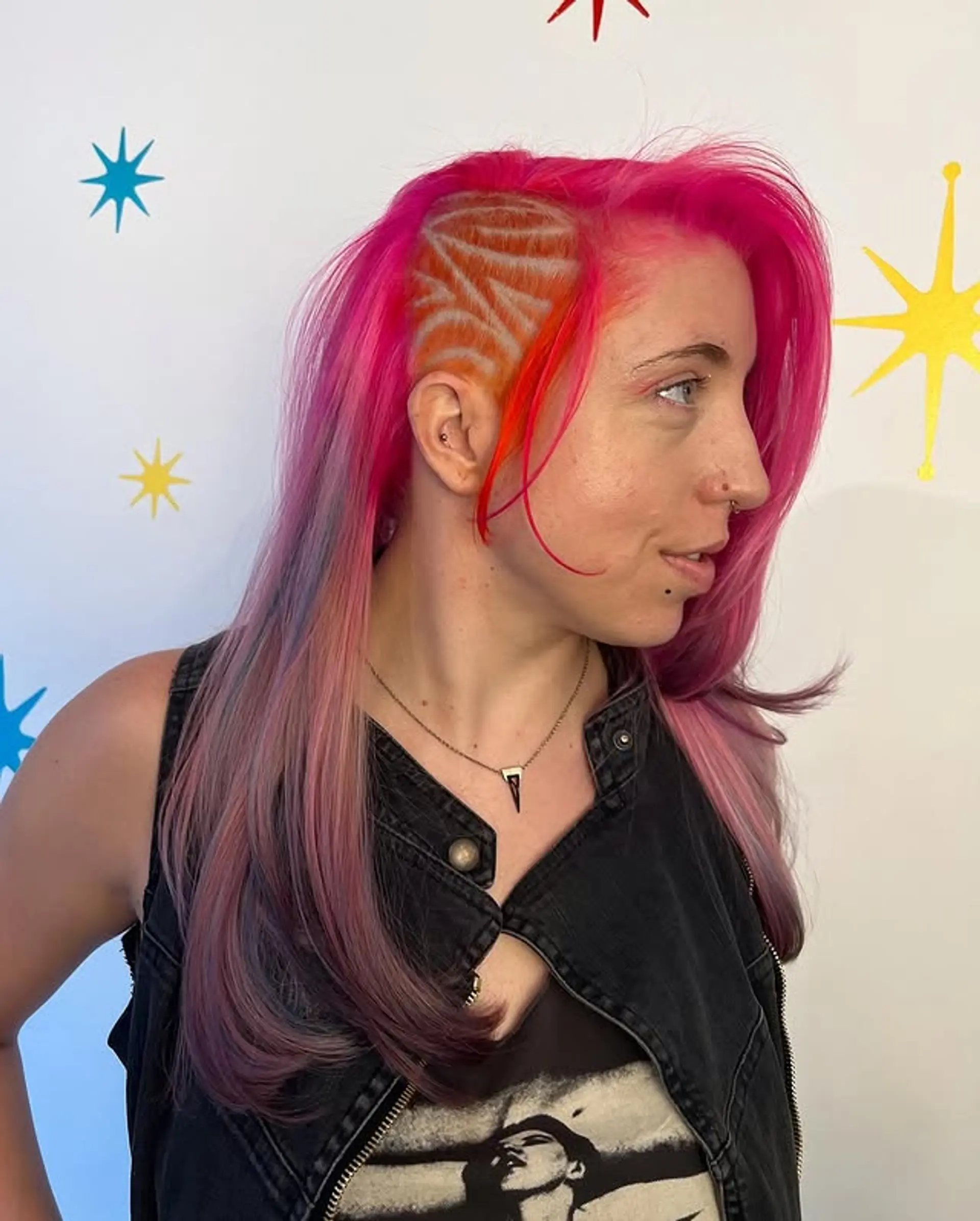 An edgy undercut with a unique hair tattoo design and vibrant fantasy colors. 1