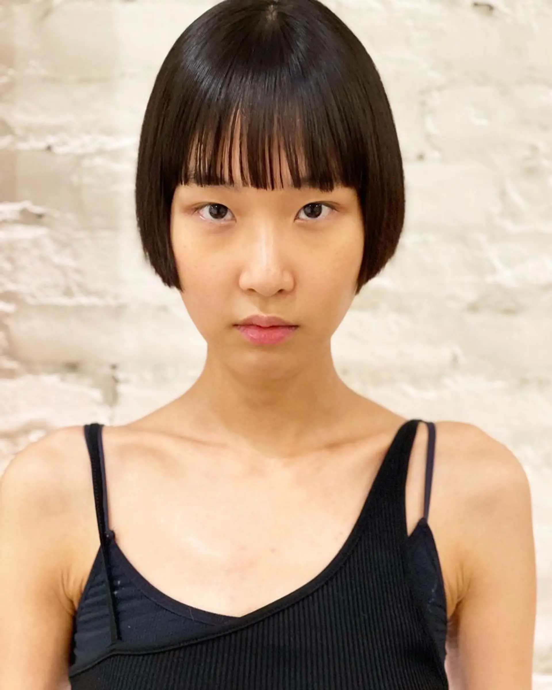 This is a modern and sleek chin length blunt bob with sharp bangs. 1