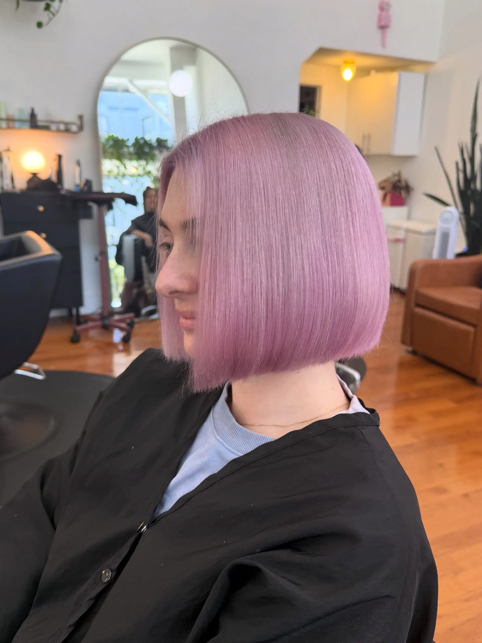 A sleek, chin-length blunt bob dyed in an even pastel lavender-lilac shade with a straight, smooth finish. 1