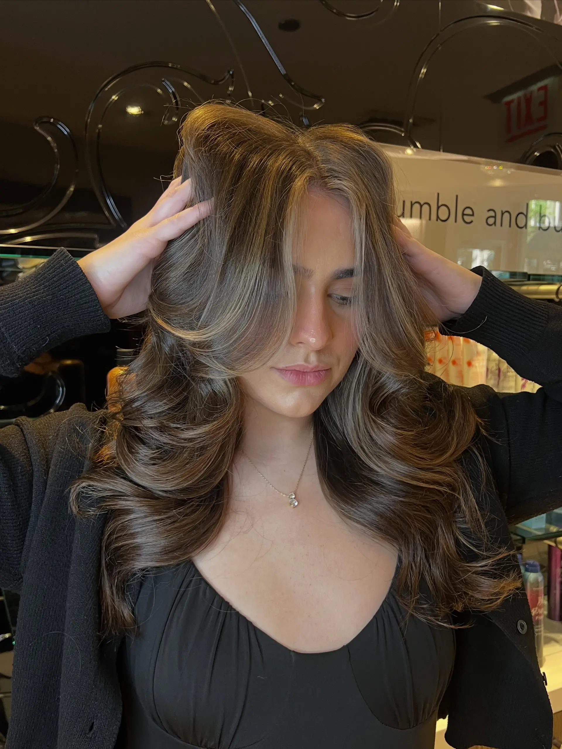 Long layered brunette hair with seamless dimensional balayage styled into a bouncy, voluminous blowout. 1