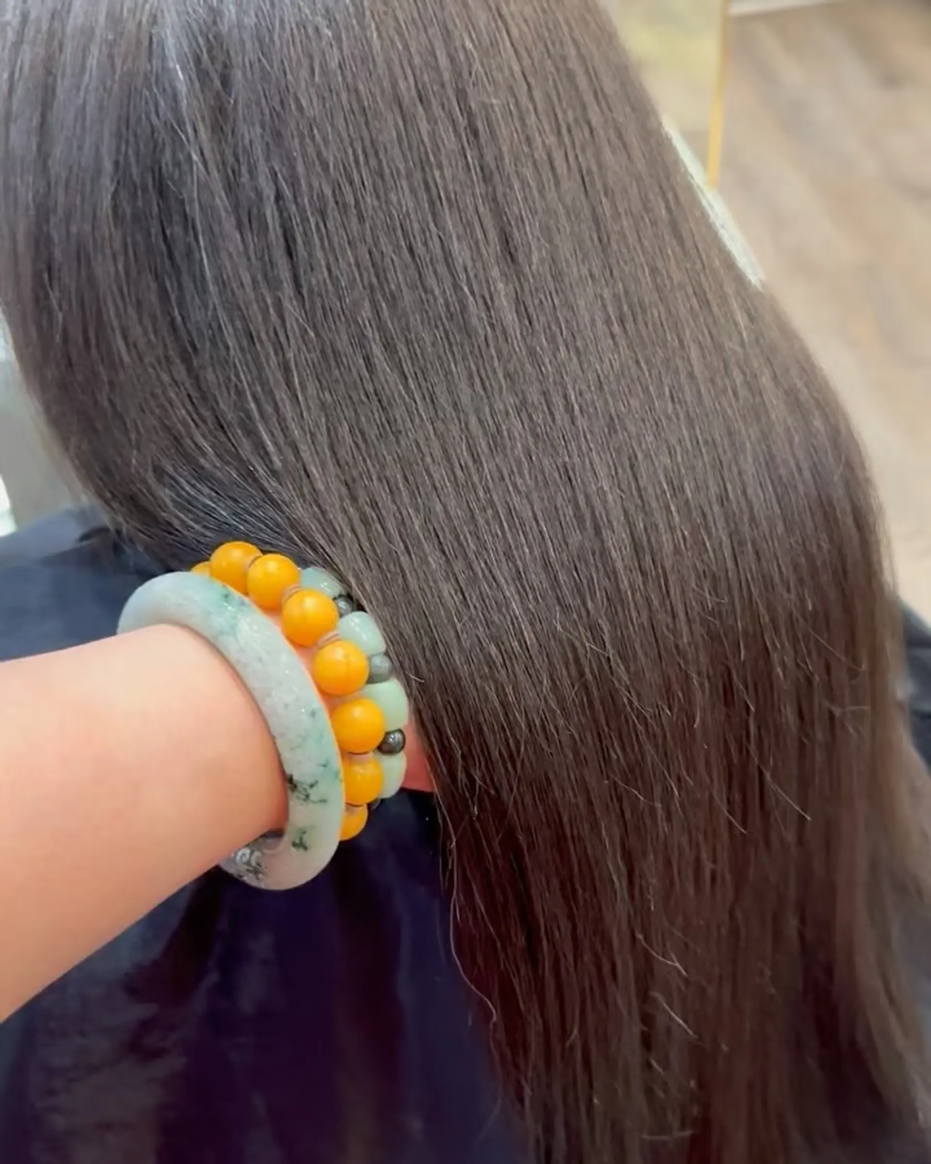 Long, pin-straight dark hair with a glossy, frizz-free texture. 1