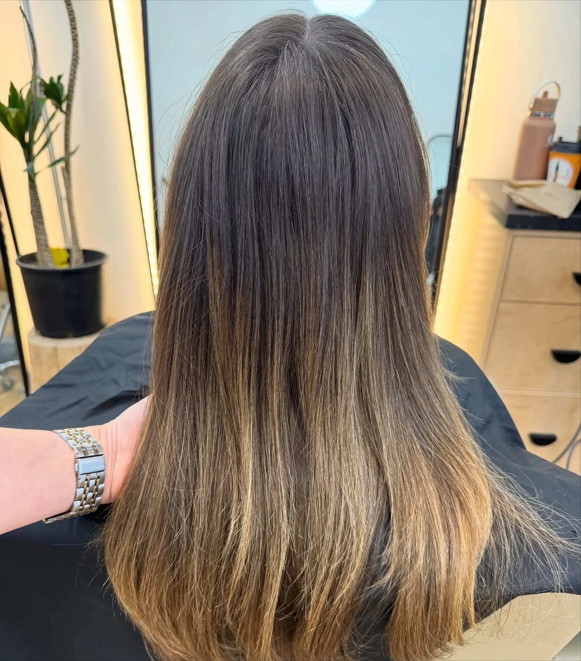Long, sleek straight hair with a rich brunette base melting into warm caramel and golden blonde ends. 1