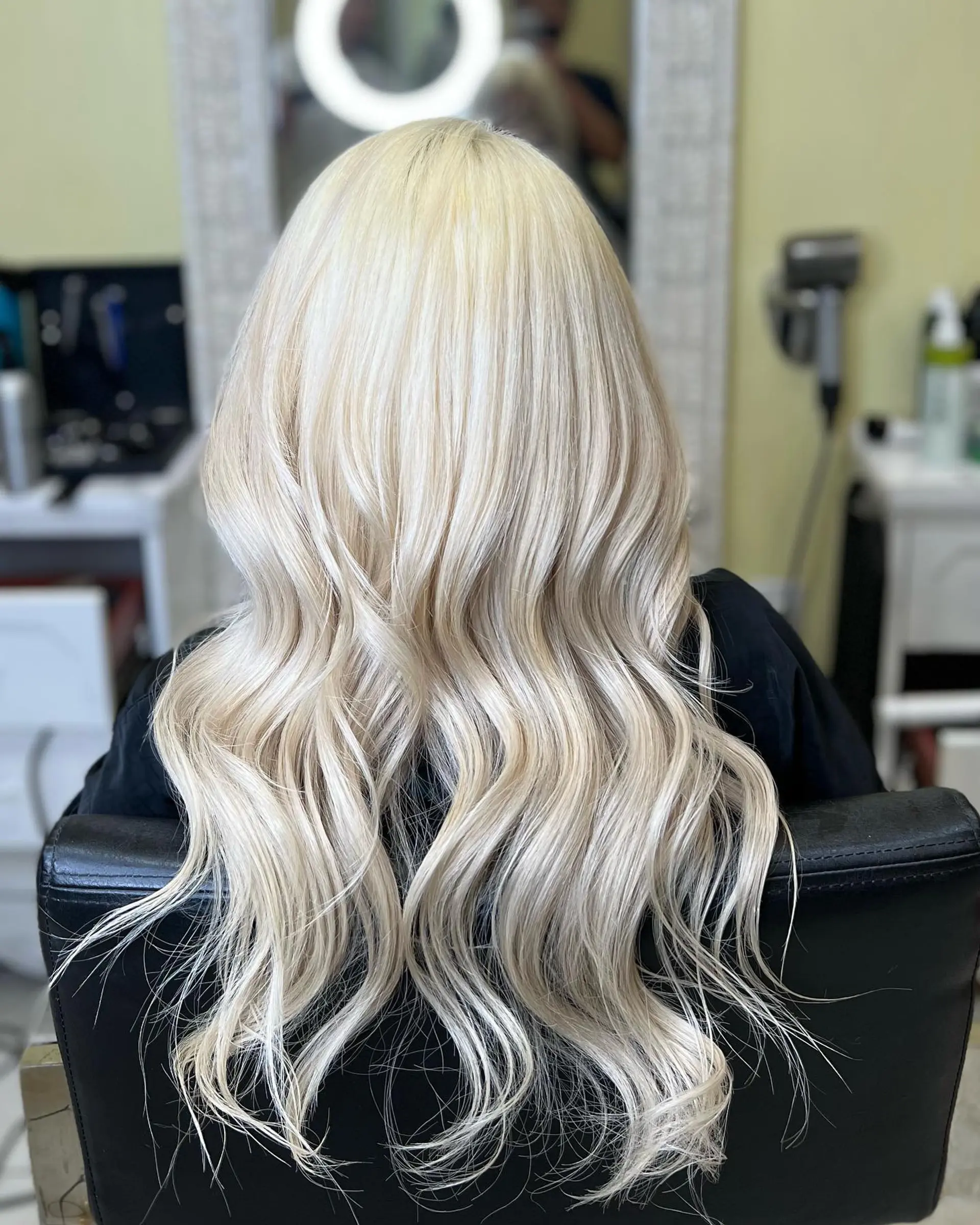 Long, layered hairstyle with soft waves, colored platinum blonde. 1