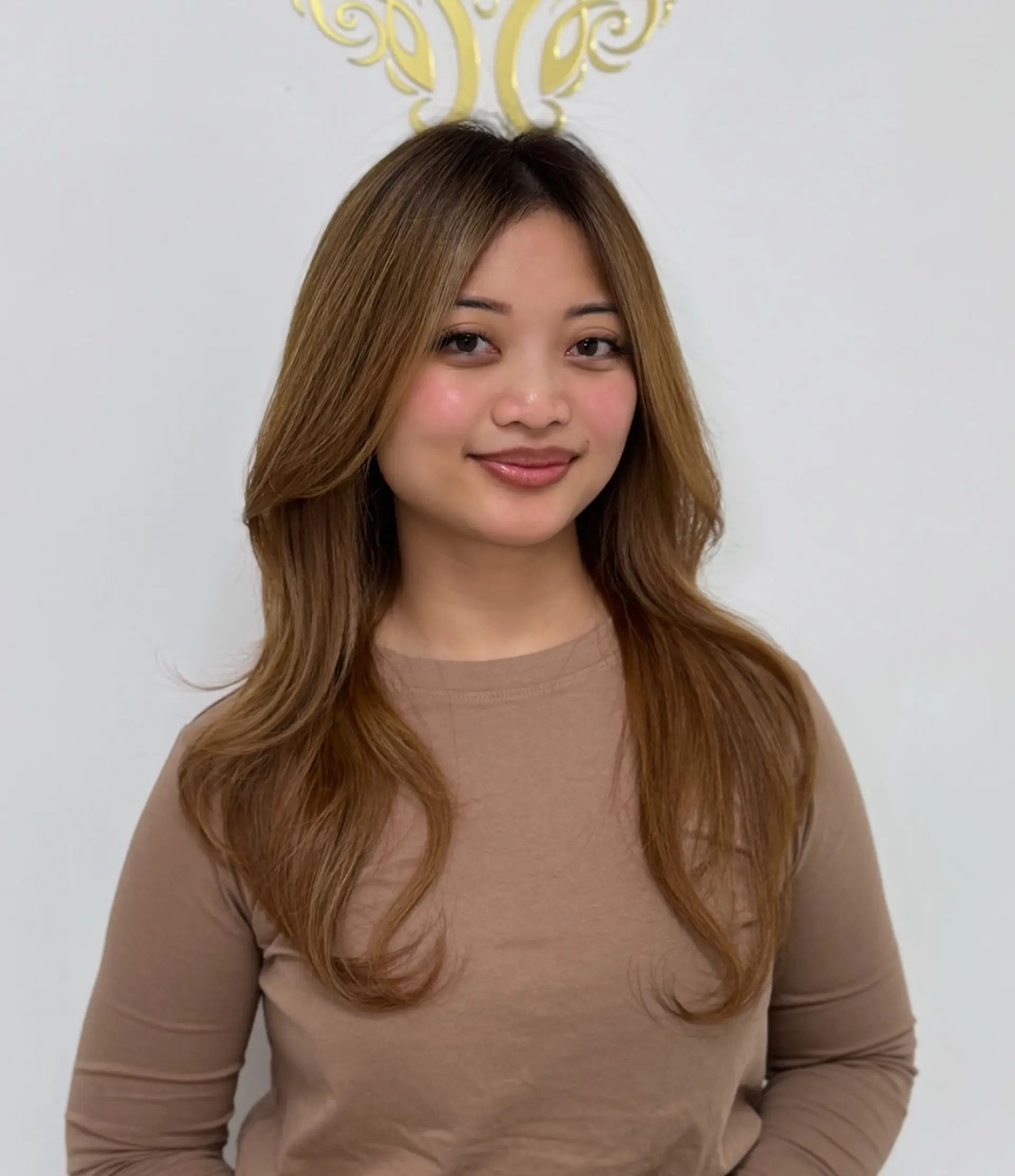 A long, layered haircut with face-framing layers that add movement and shape. 1