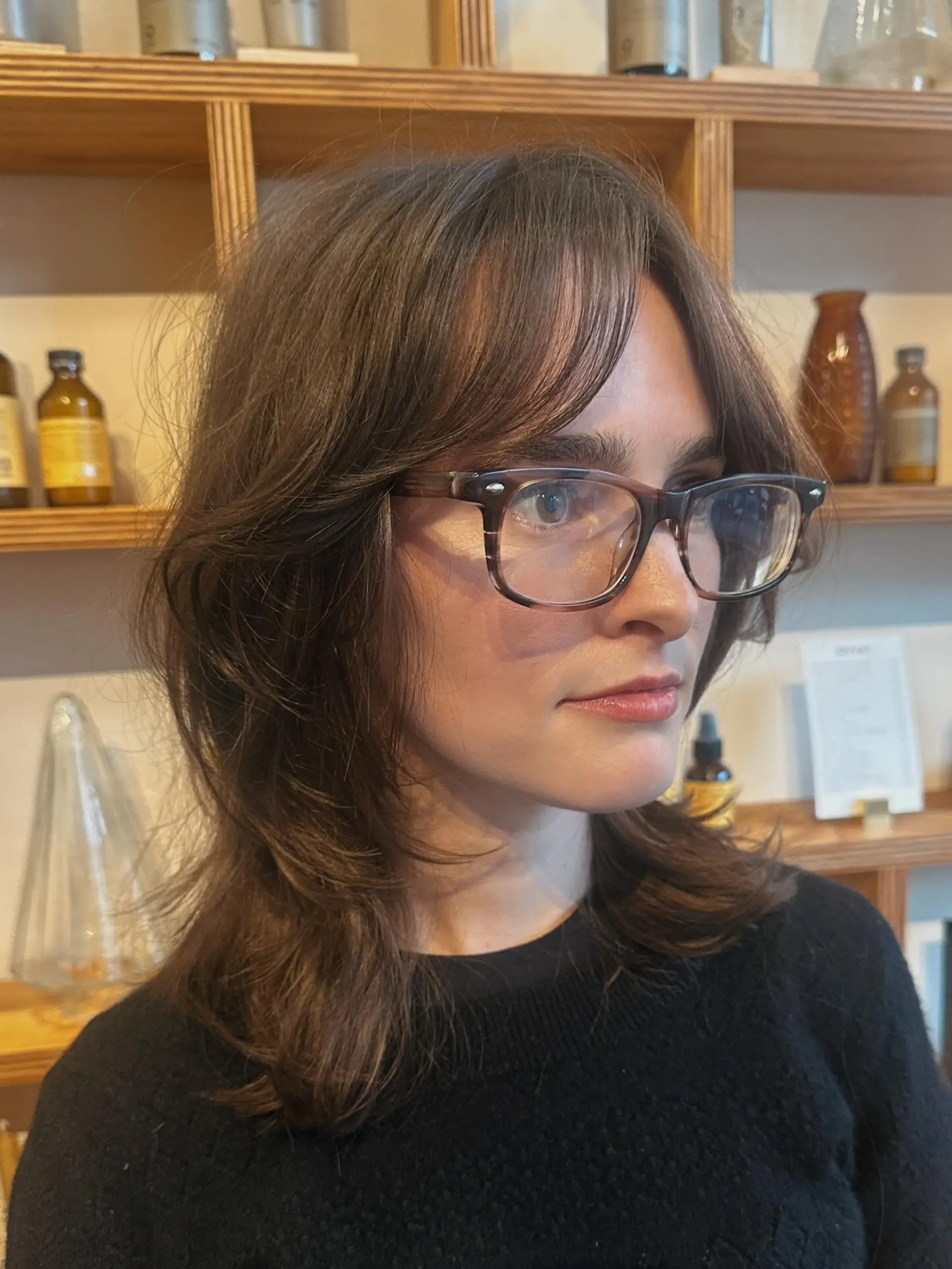 Medium-length dark brown shag featuring curtain bangs and textured layers. 1