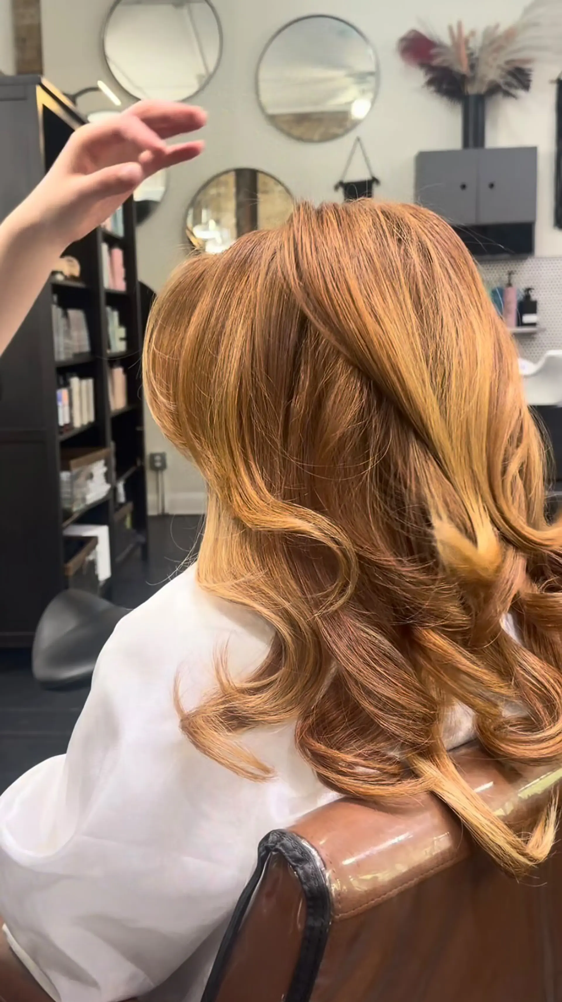 A voluminous layered blowout with soft, bouncy curled ends in a warm copper tone. 1