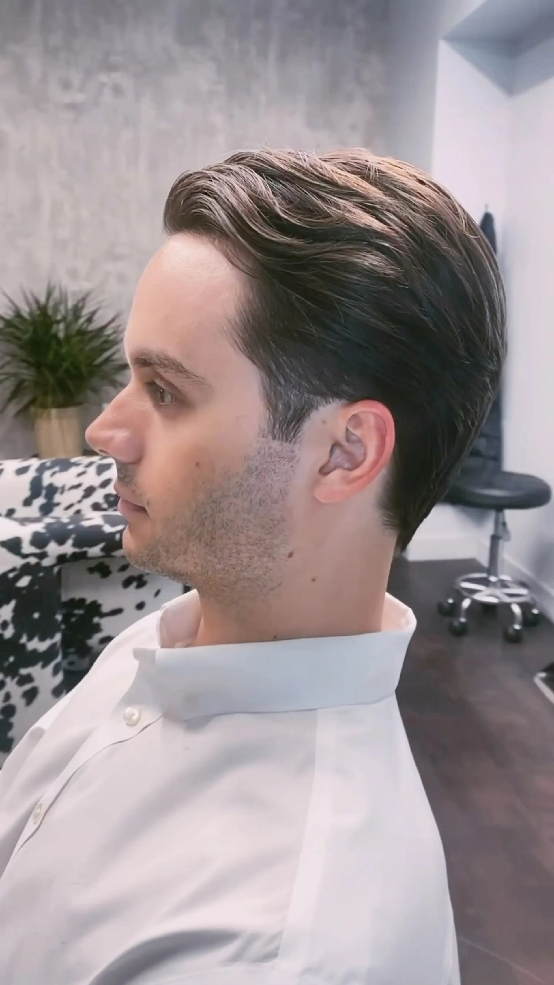 A classic men's haircut with clean scissor-tapered sides and a smooth, swept-back top. 1