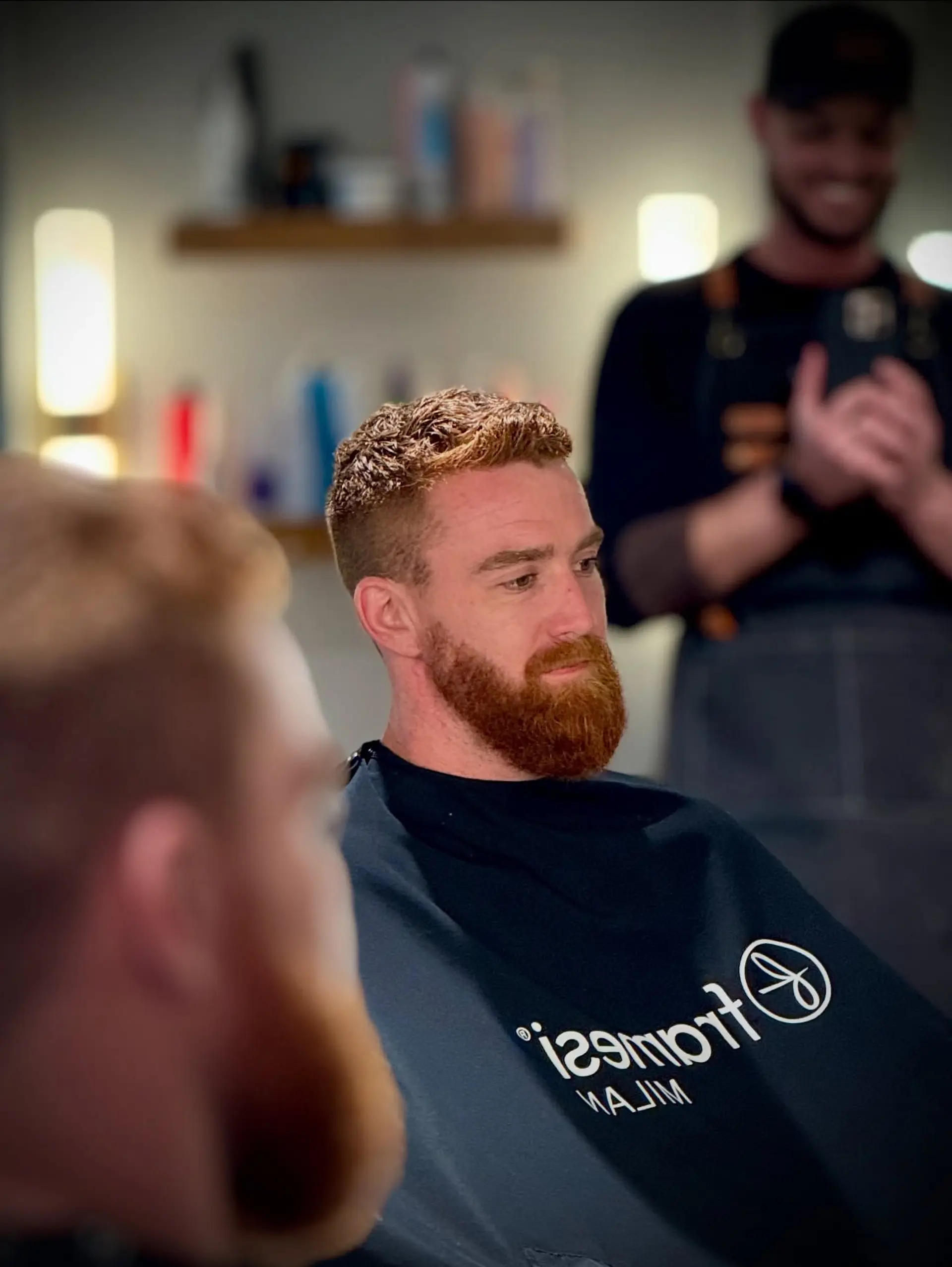 A men's short haircut featuring clipped, faded sides and a textured top, paired with a well-groomed, full red beard. 1