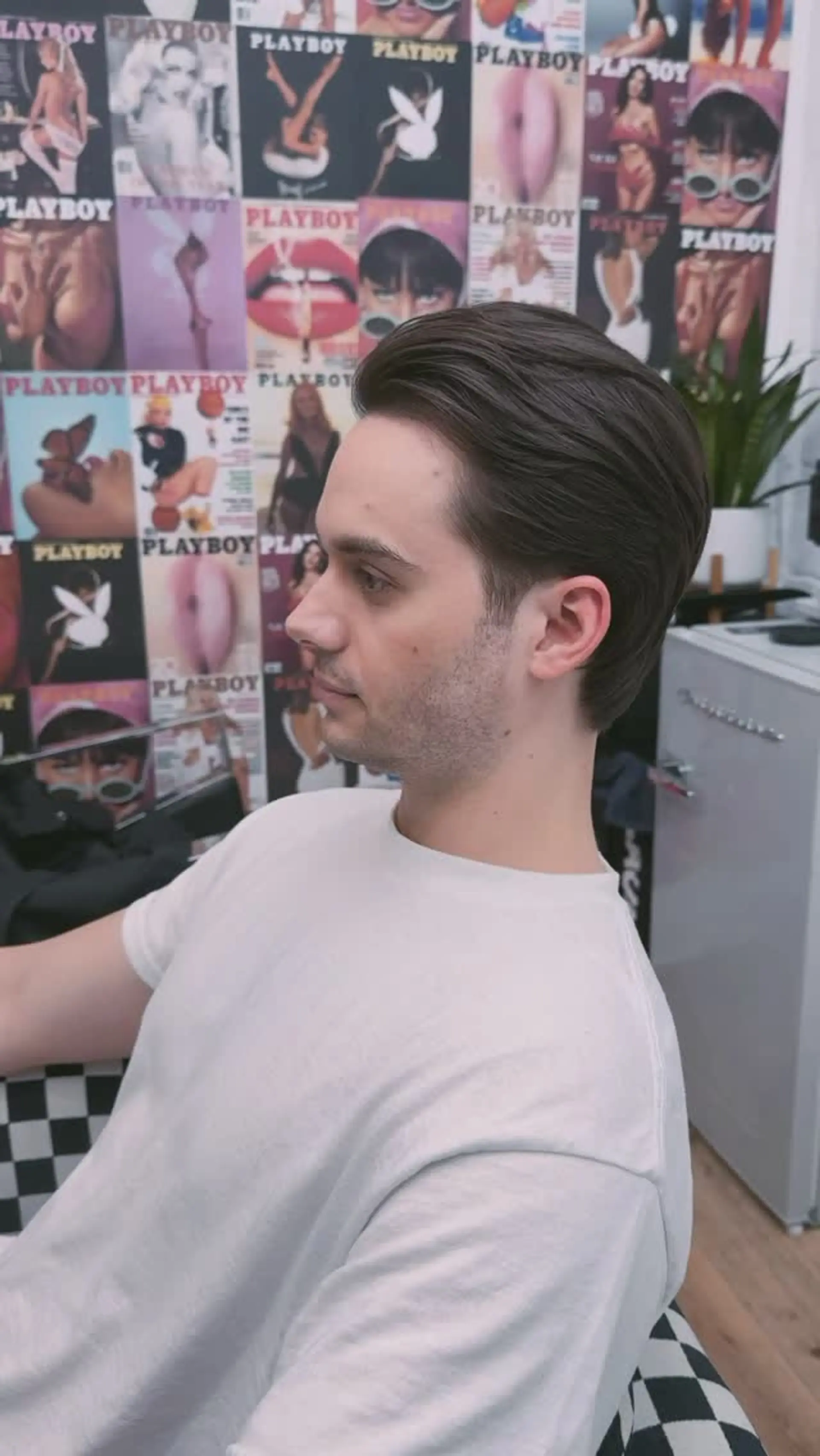 Medium-length haircut brushed neatly back away from the face, featuring soft scissor shaping around the ears and a natural, flowing silhouette. 1