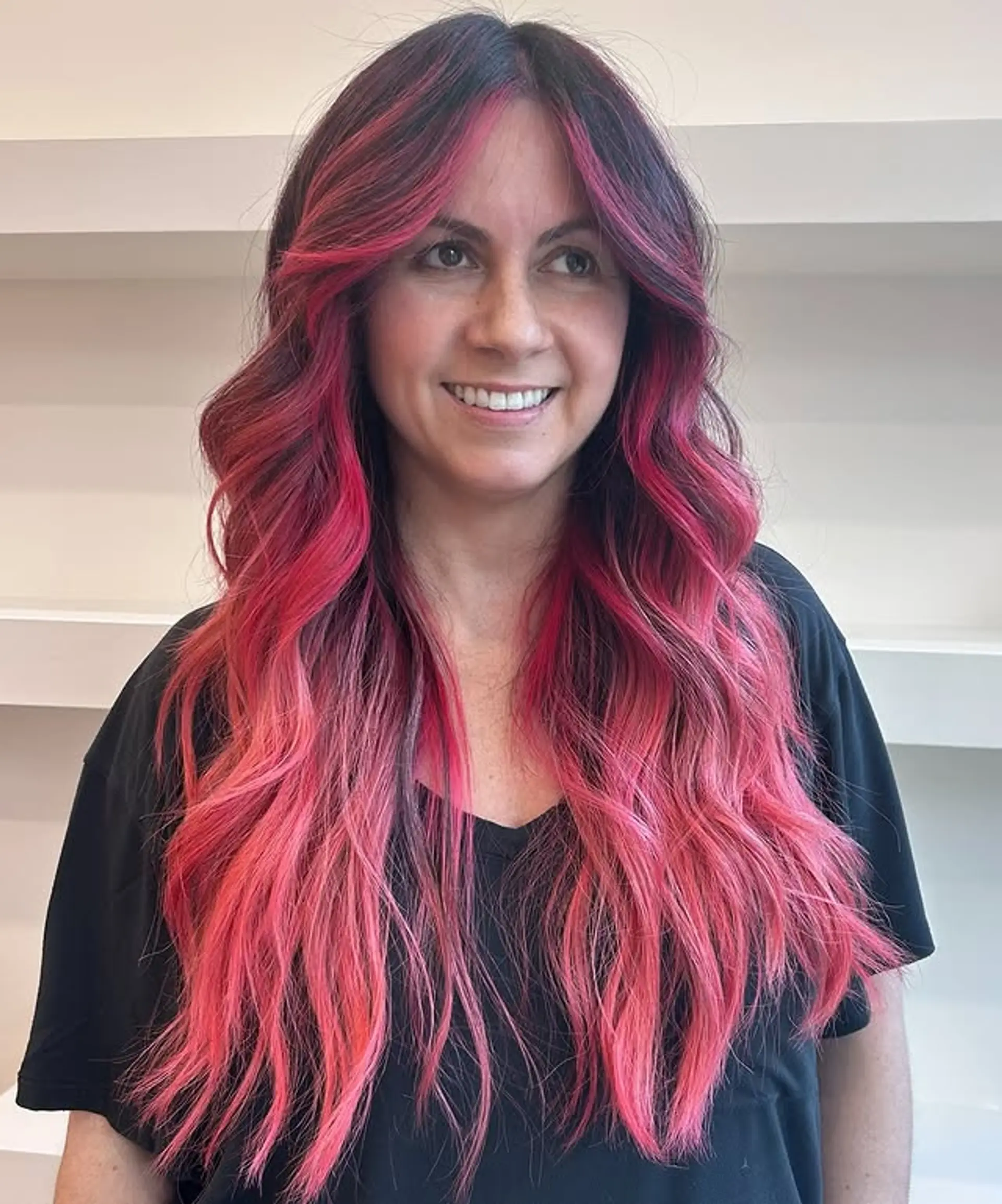 Long wavy hair with a pink ombre and face-framing layers. 1