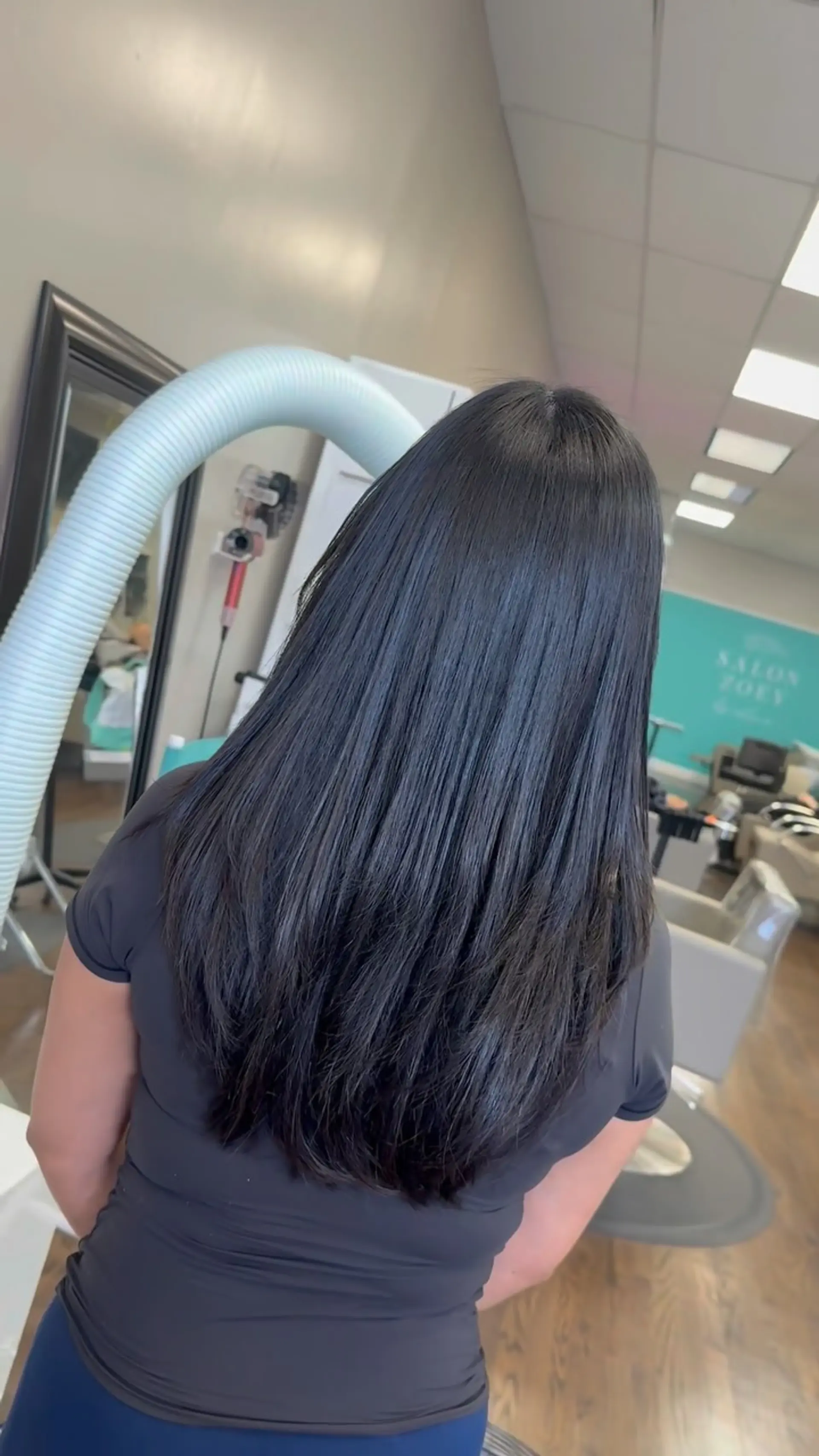 Ultra-smooth, glossy dark hair styled straight with subtle layering towards the ends. 1