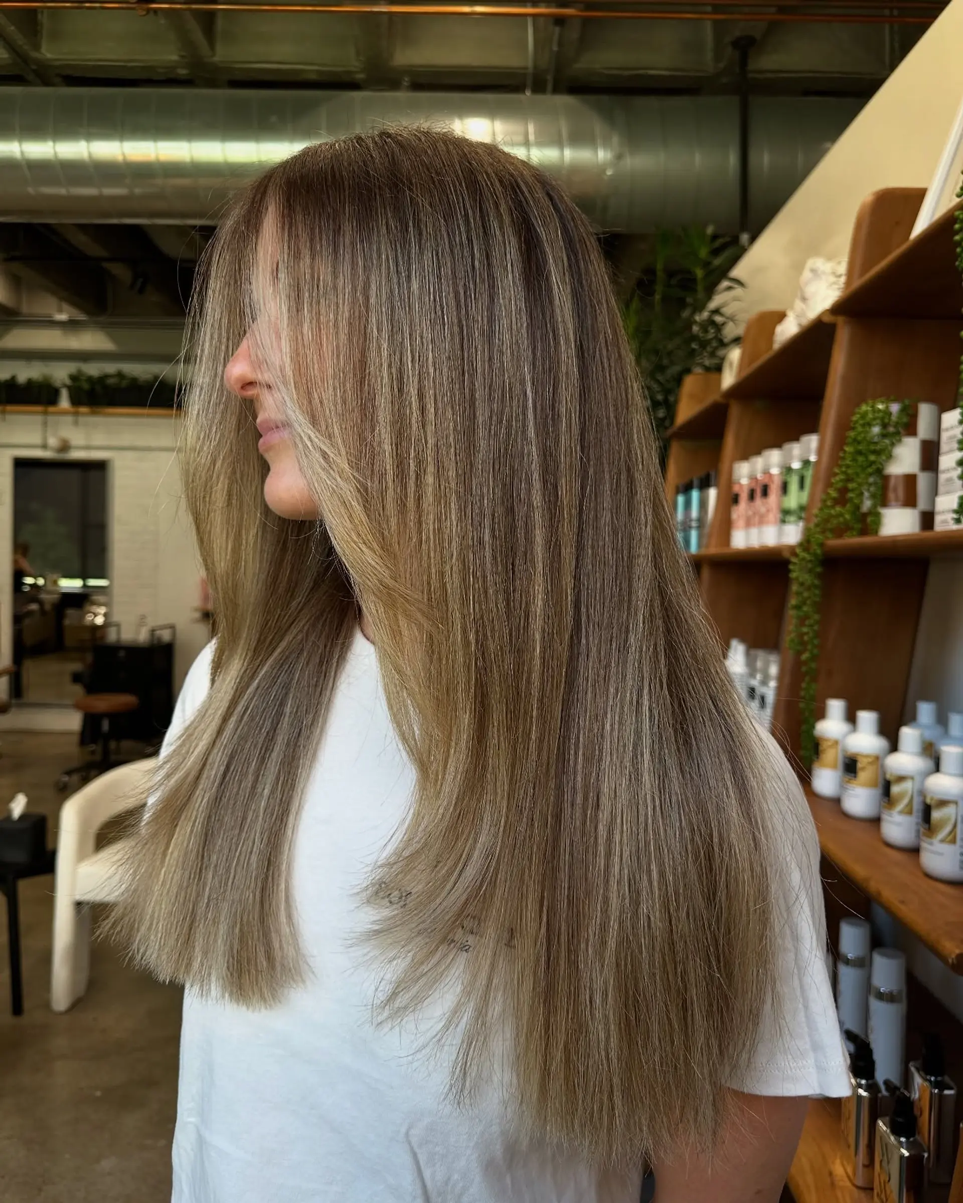 A long, layered hairstyle with face-framing layers and a modern bronde balayage. 2