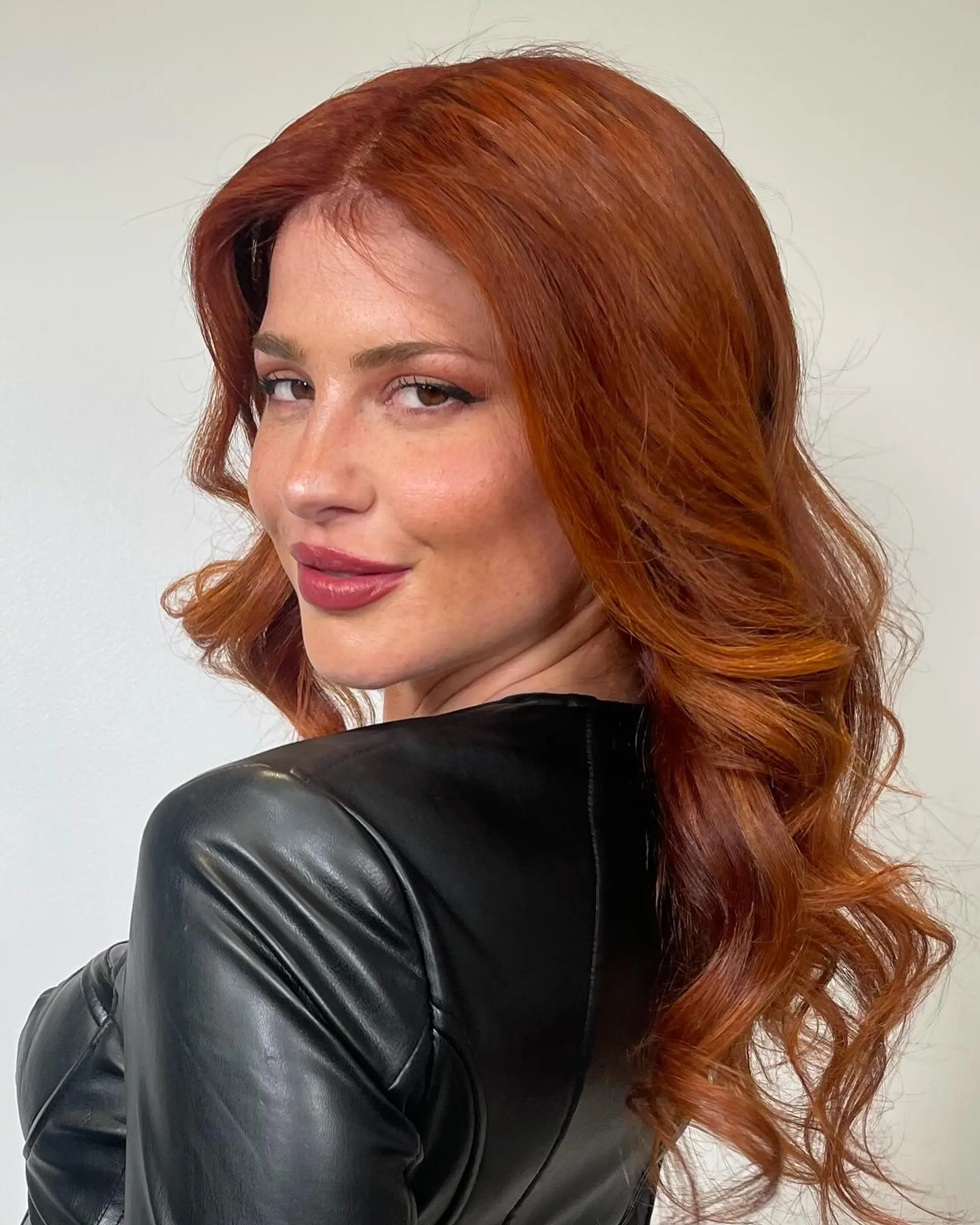 Vibrant copper-toned long hair with soft, voluminous waves. 1