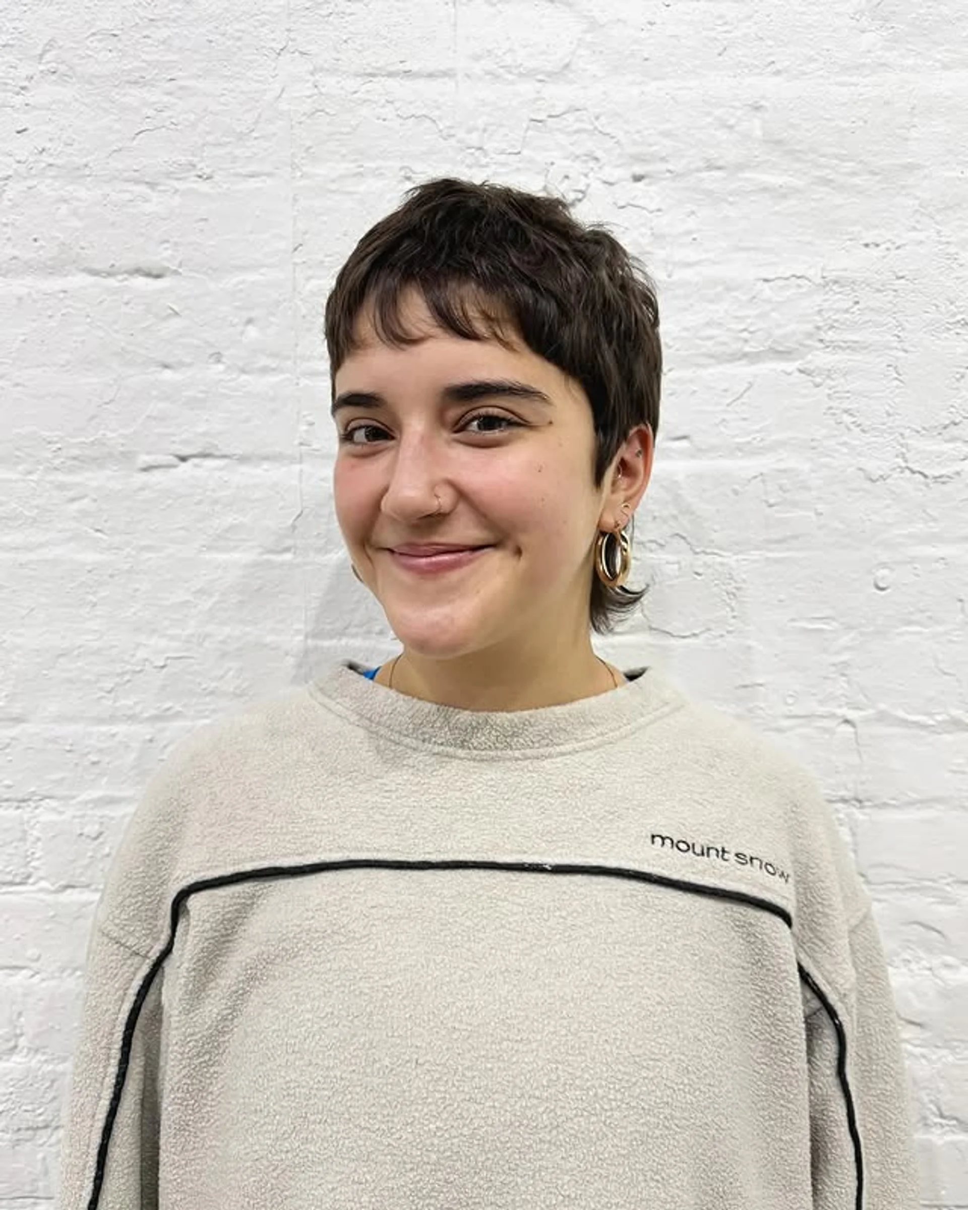 Edgy pixie bob with bangs styled dynamically for a transitional grow-out look - Preview 3