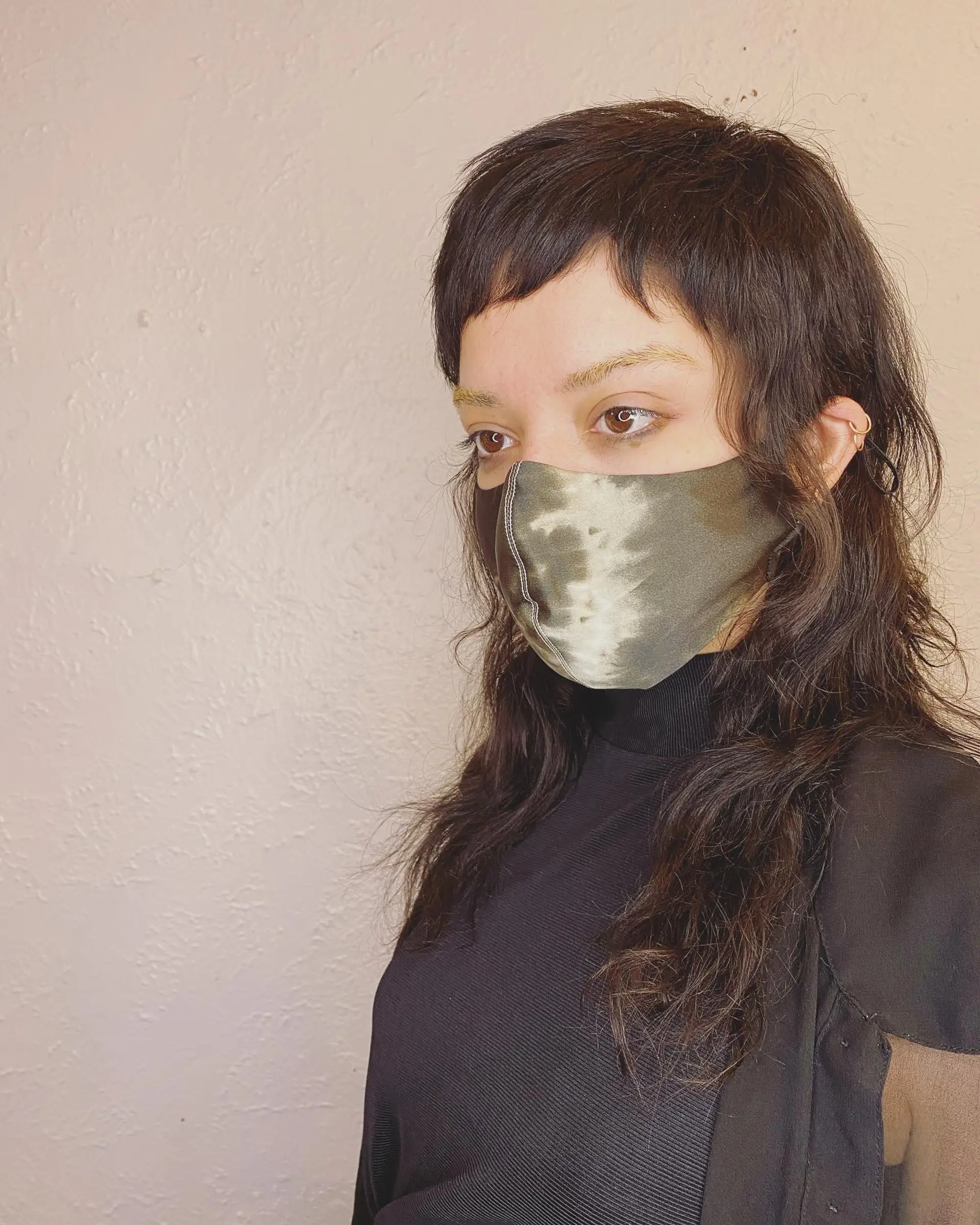 A shaggy mullet with choppy layers and blunt baby bangs. 1