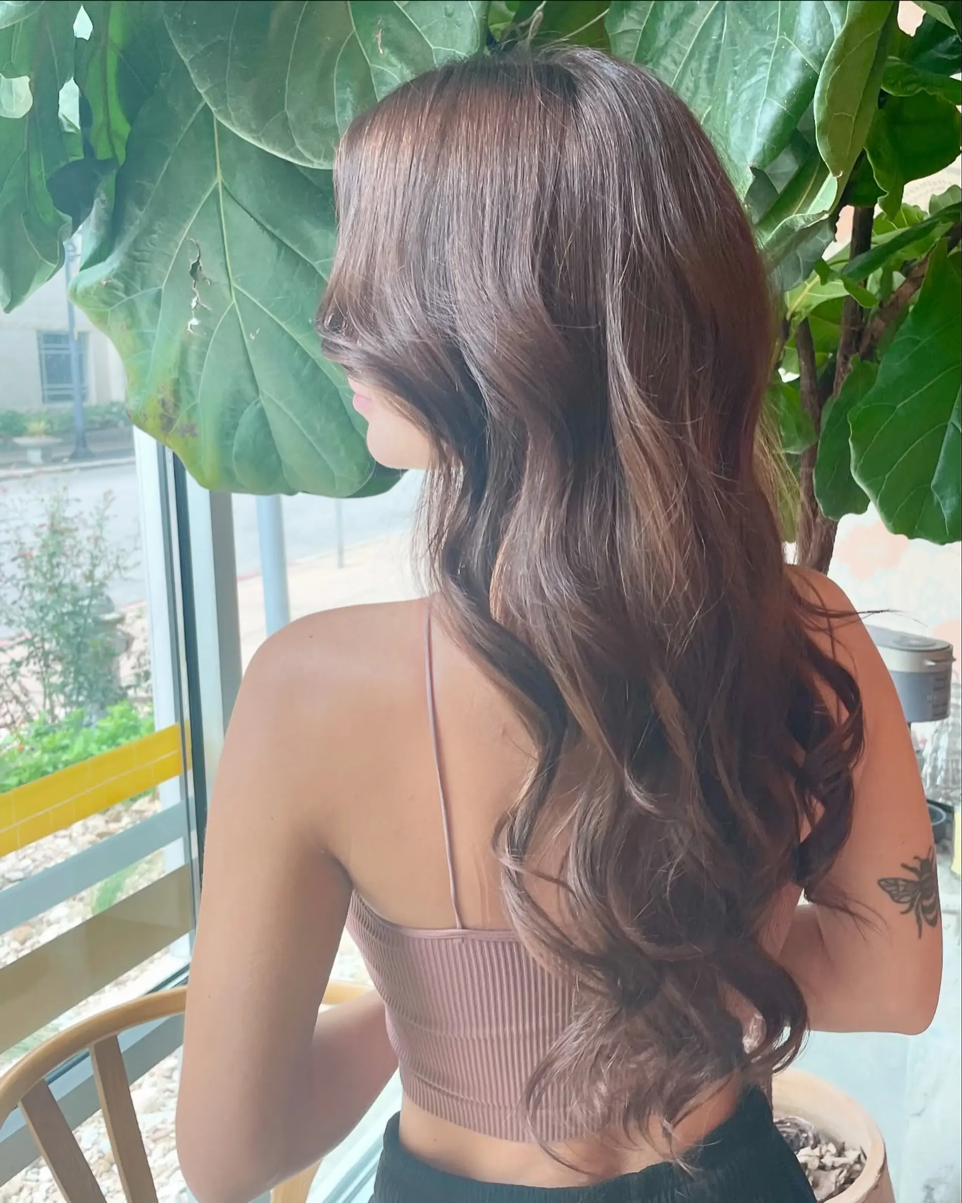 Long, dimensional brunette hair styled into soft, cascading loose waves. 1