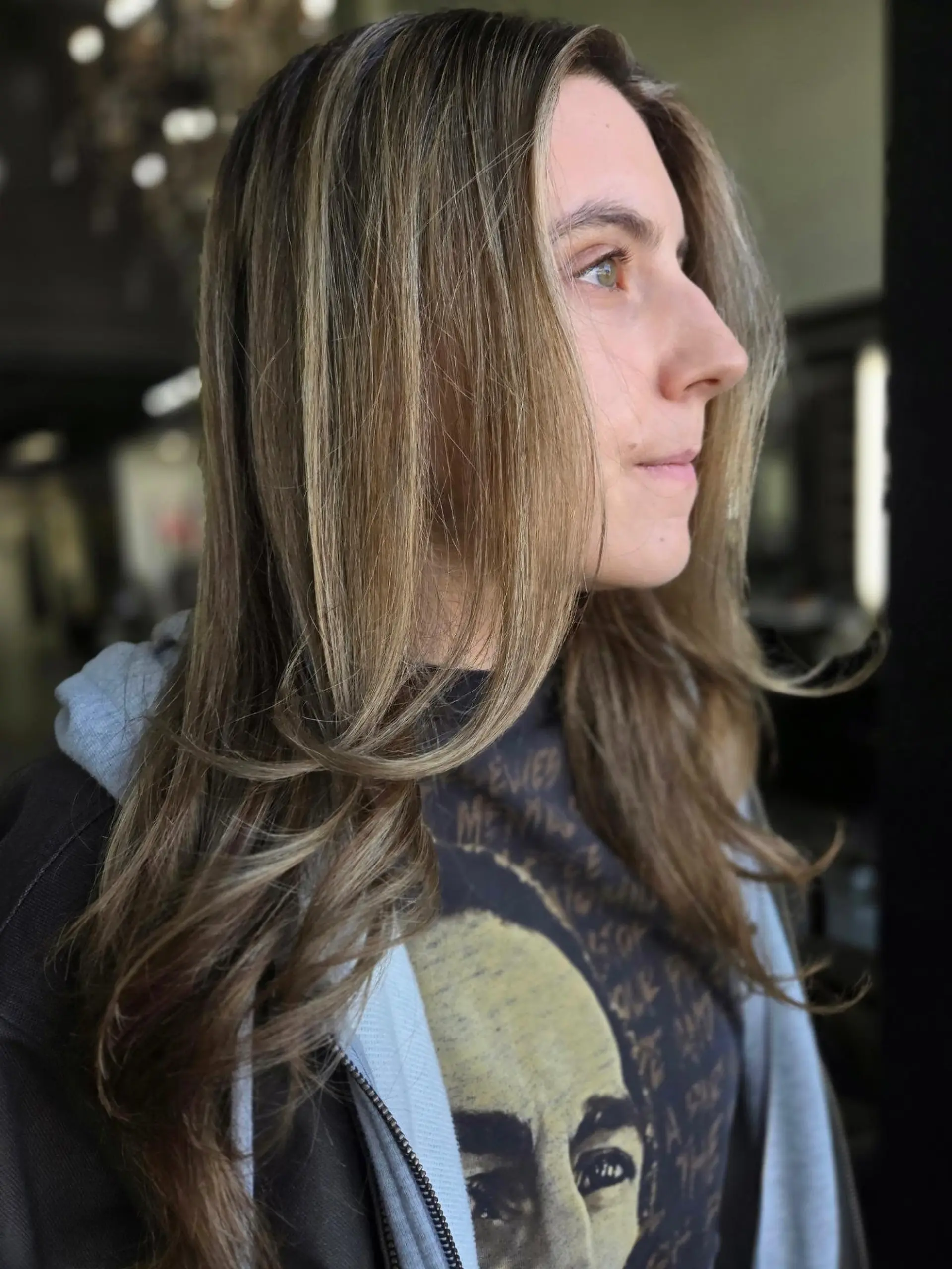 Soft sun-kissed sombre with blended honey blonde highlights, face-framing layers, and gently curved ends. 1