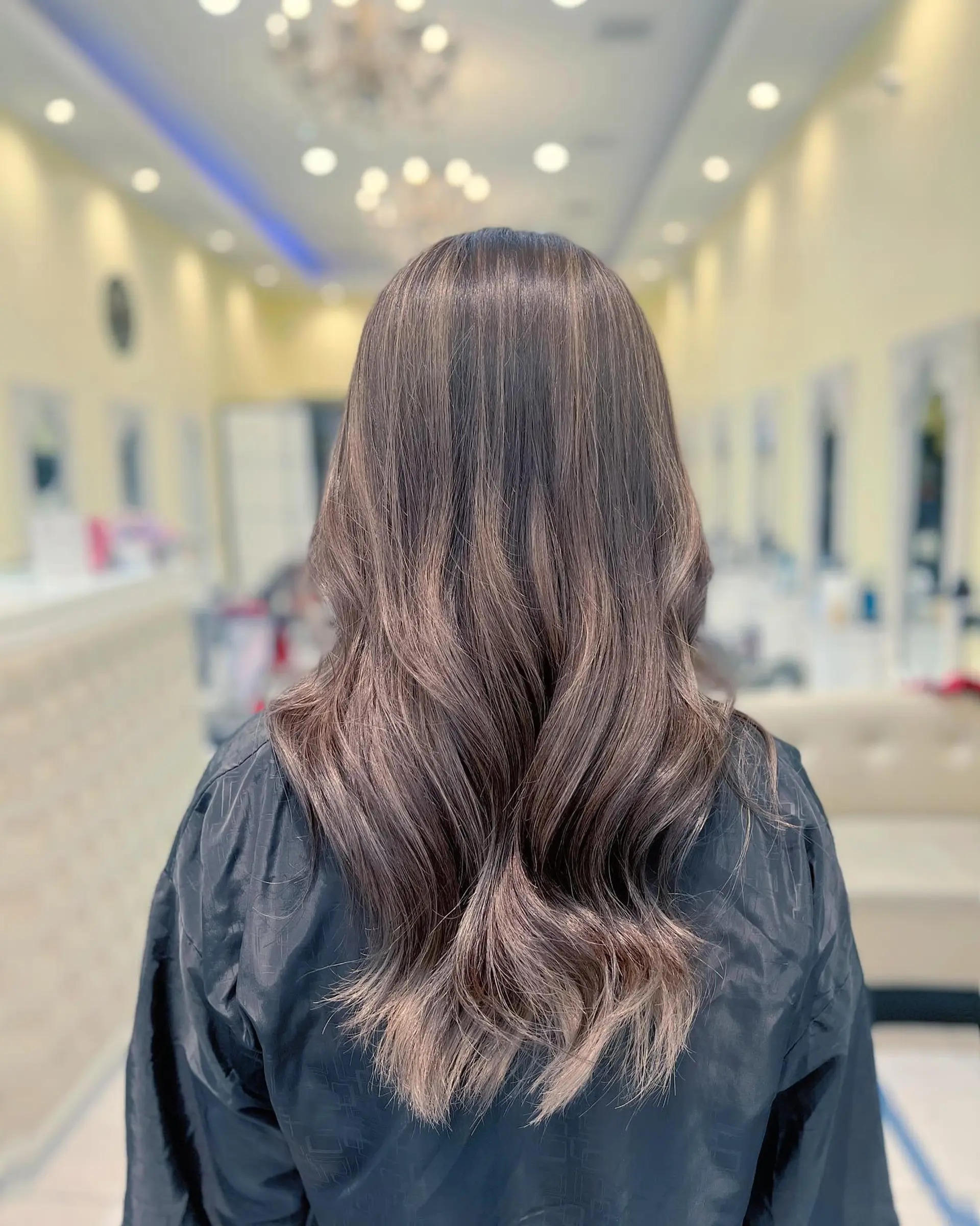 A bronzed brown hair color with light blonde highlights and soft waves. 1